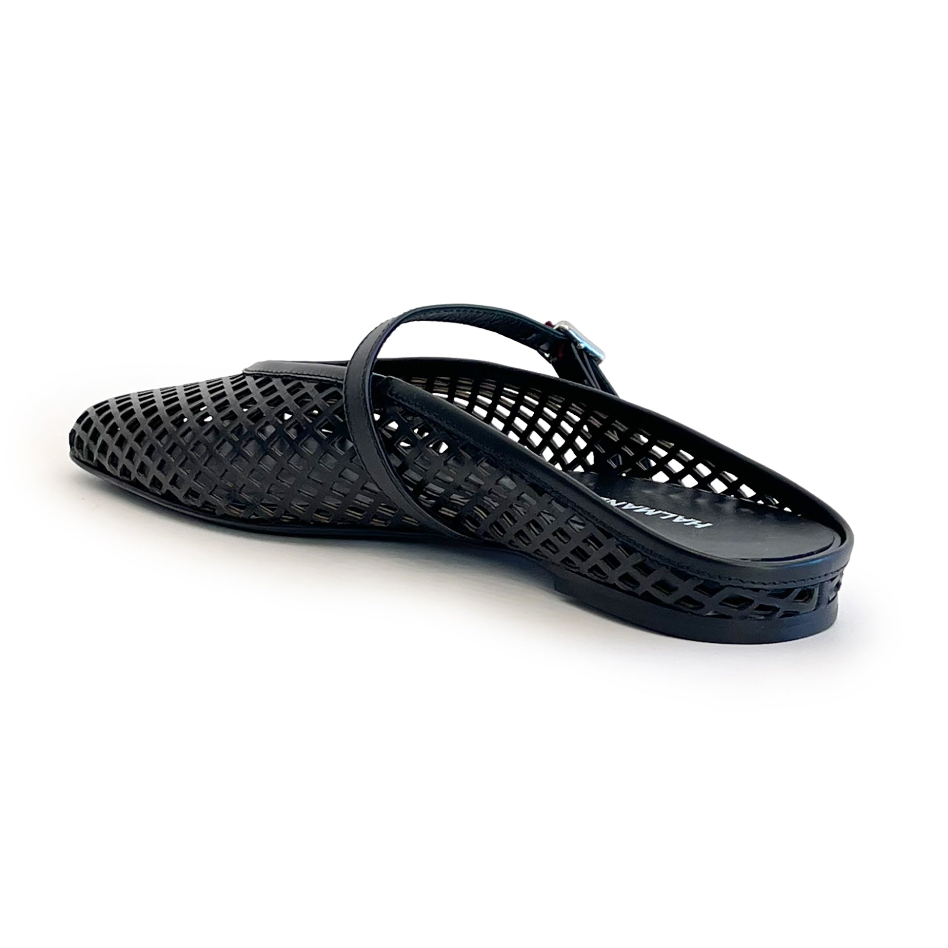 Black laser cut leather strap slip on flat shoe on a white background