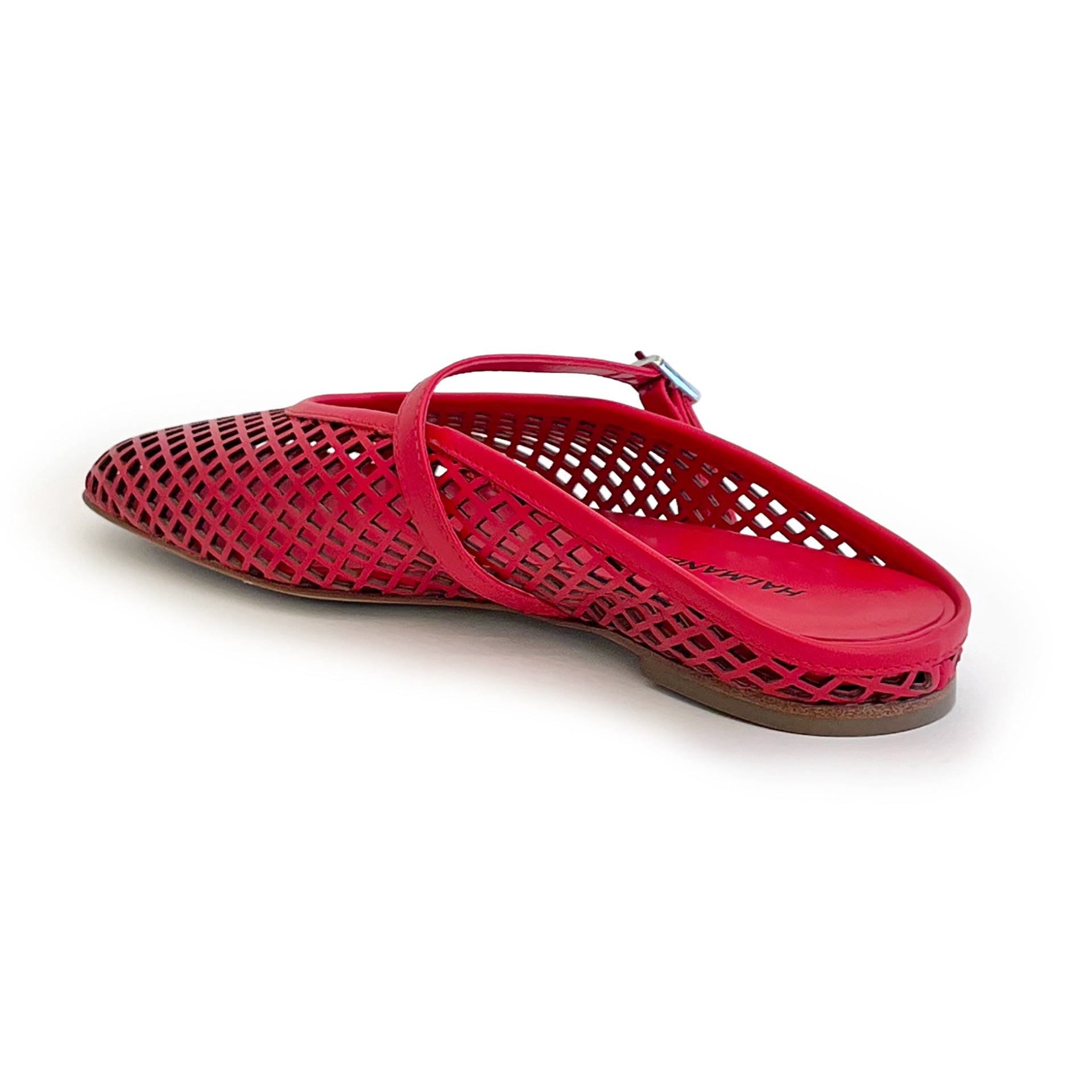 Red laser cut leather strap slip on flat shoe on a white background