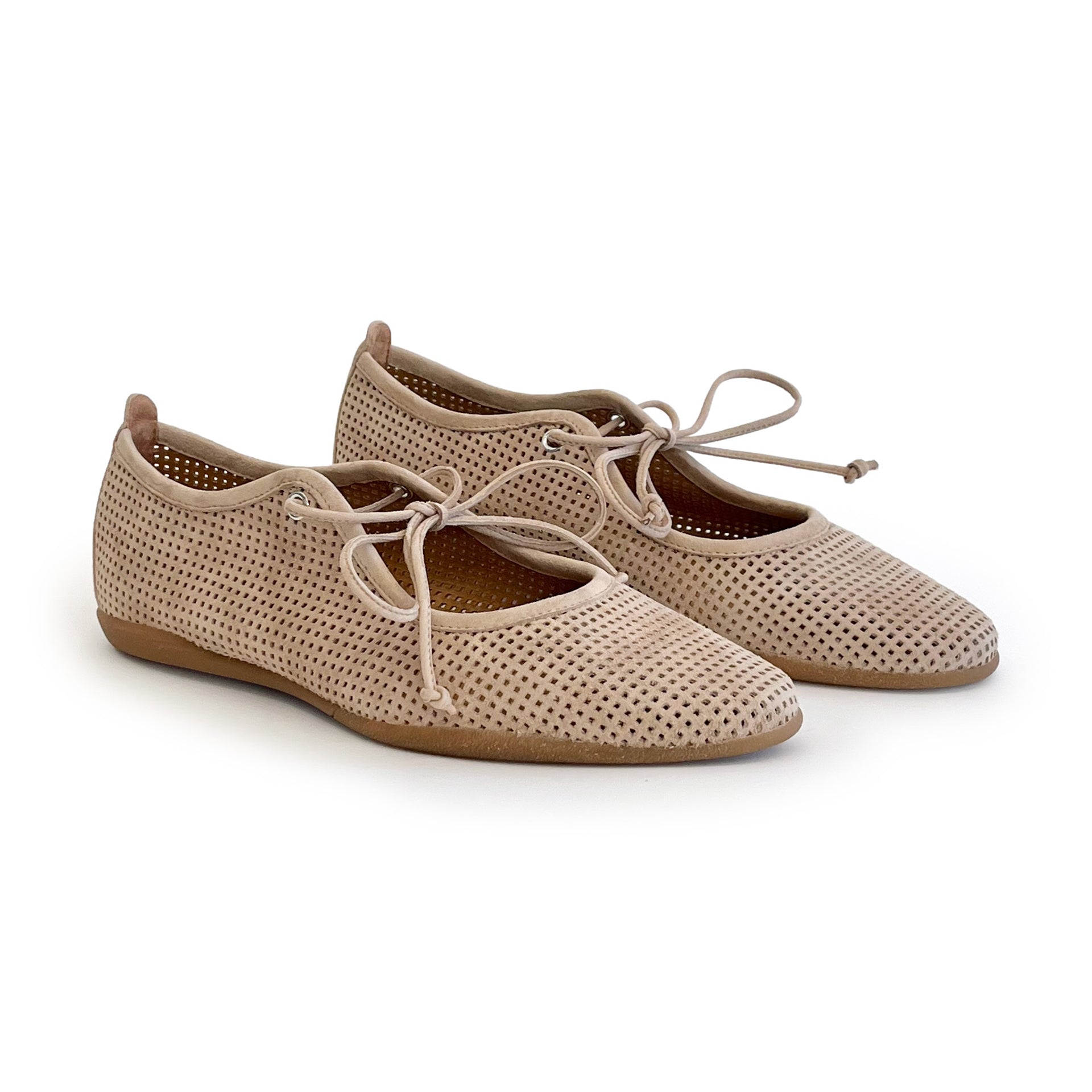 Beige perforated suede ballet flat shoes on a white background