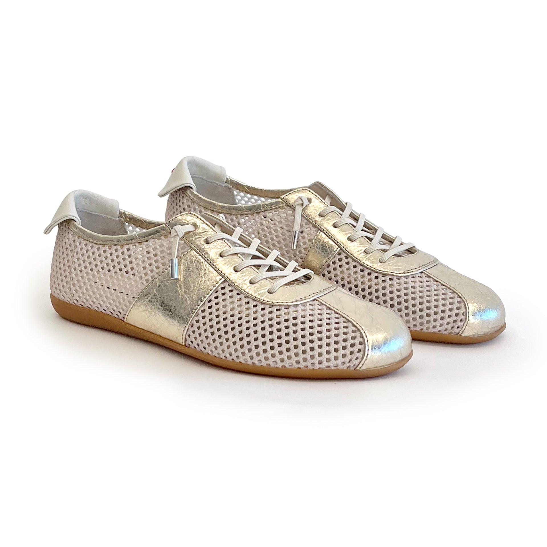 White mesh sneakers with metallic leather contrast on a white background