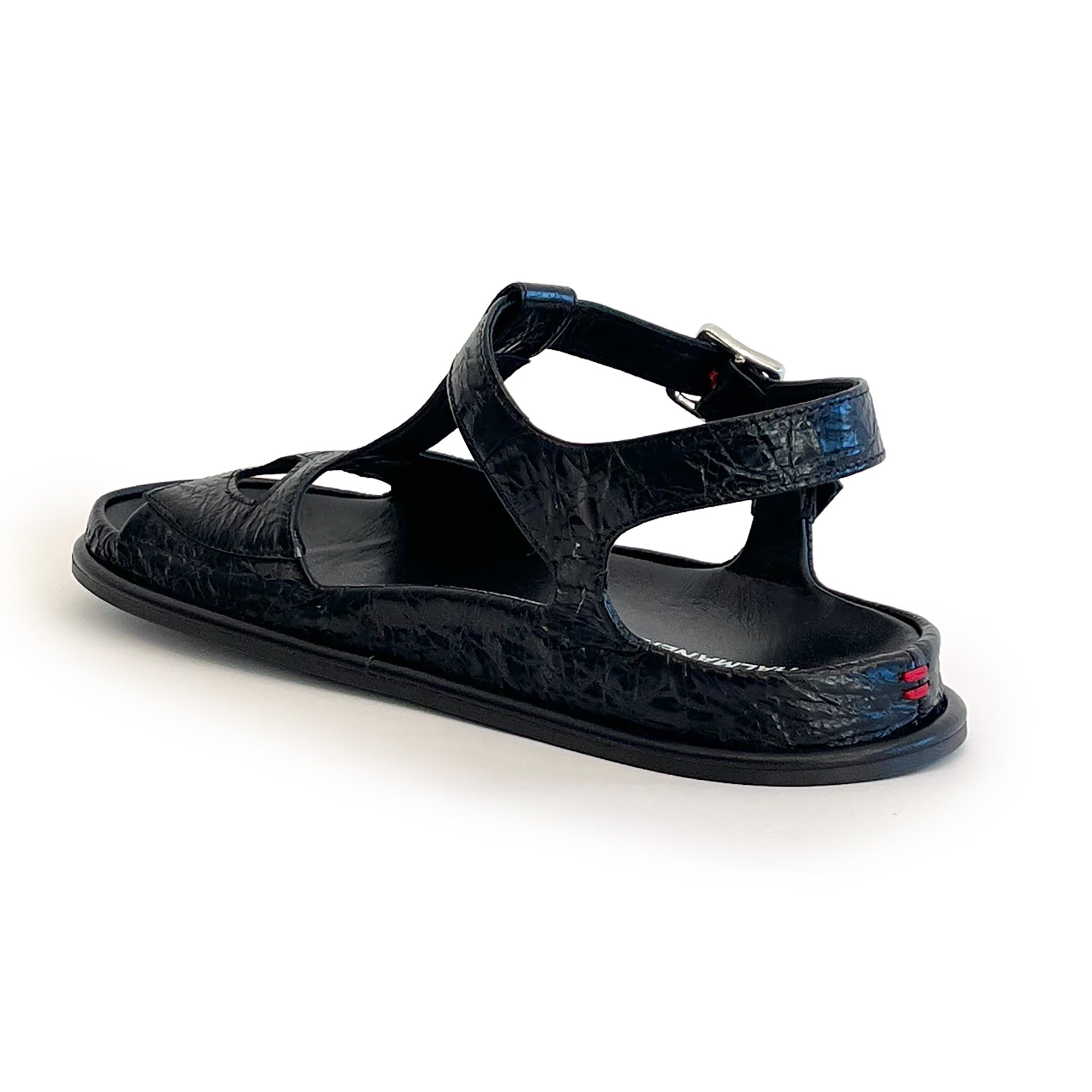 Black ankle strap flat sandal on a white background