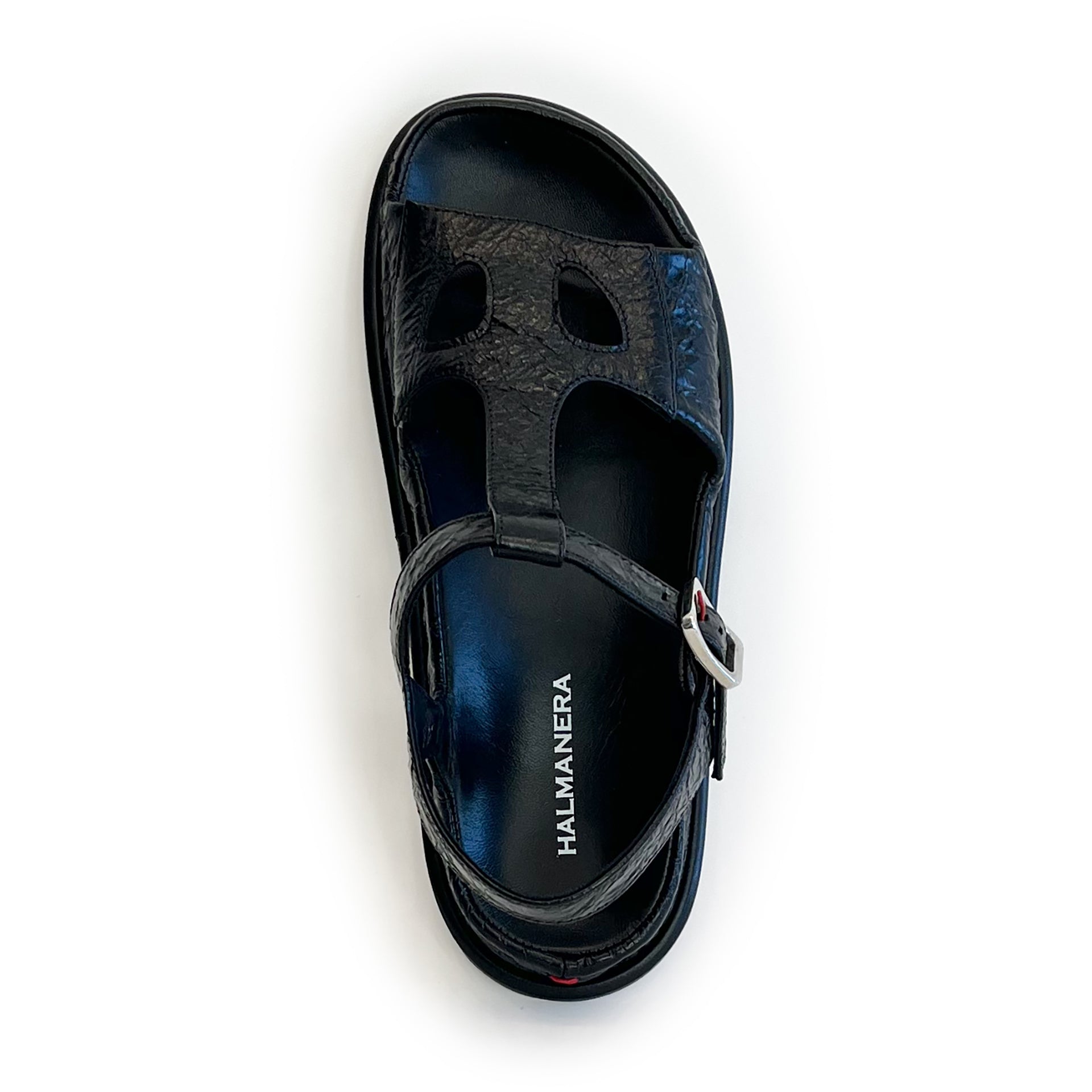 Black ankle strap flat sandal on a white background