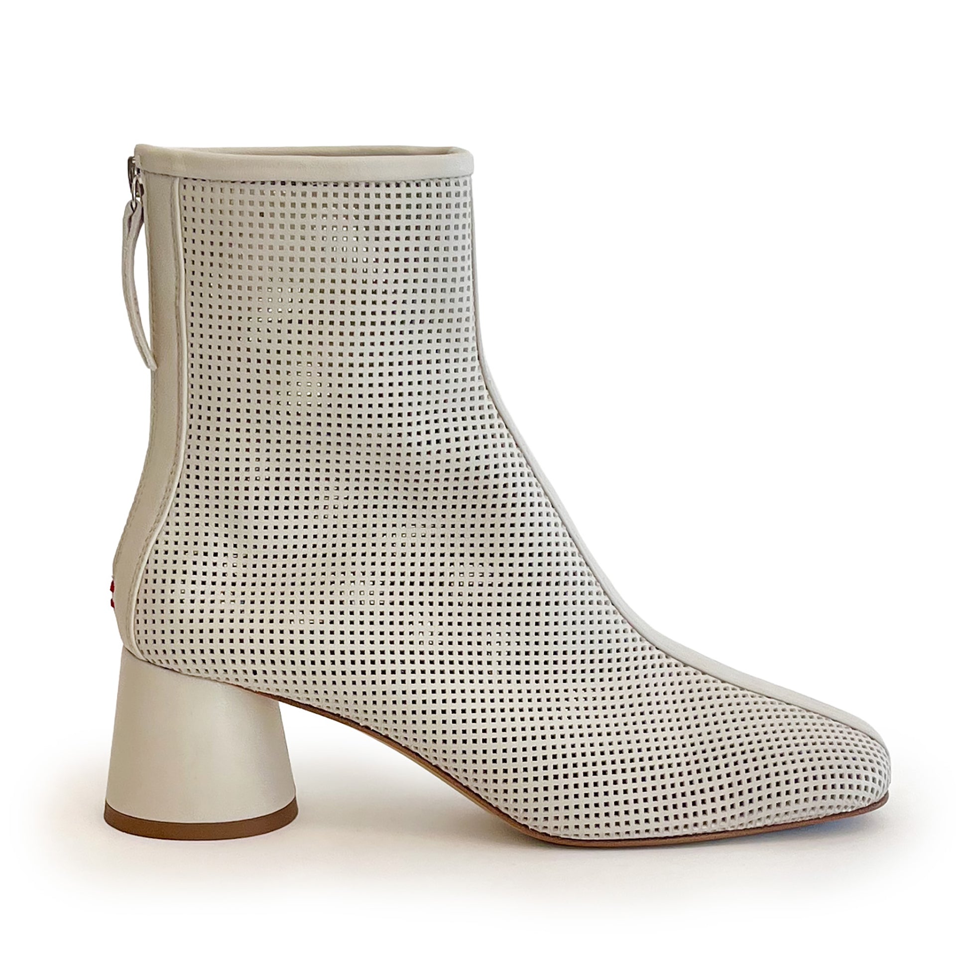 Beige round toe perforated ankle boot on a white background