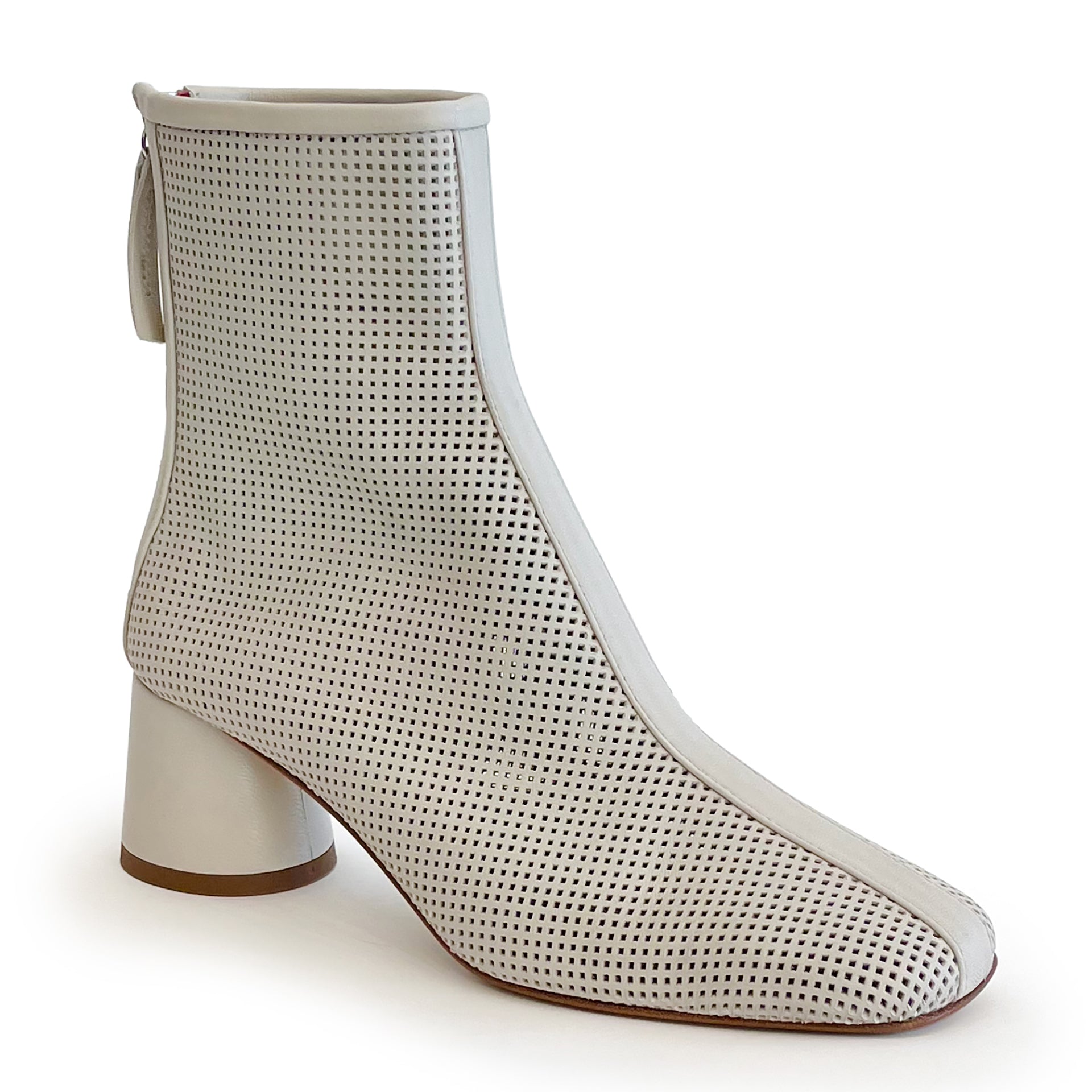 Beige round toe perforated ankle boot on a white background