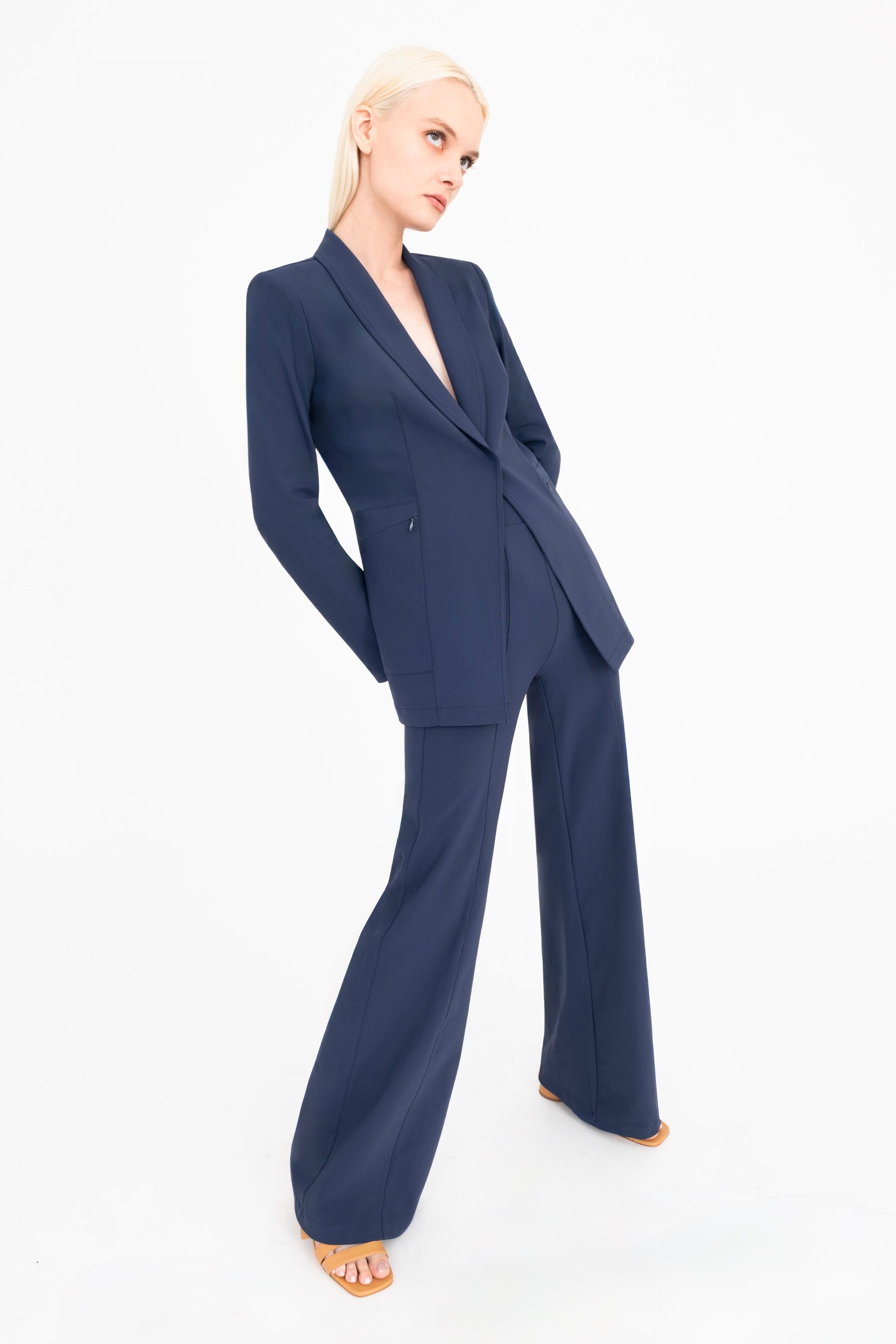 Woman wearing a navy blue suit on a white background