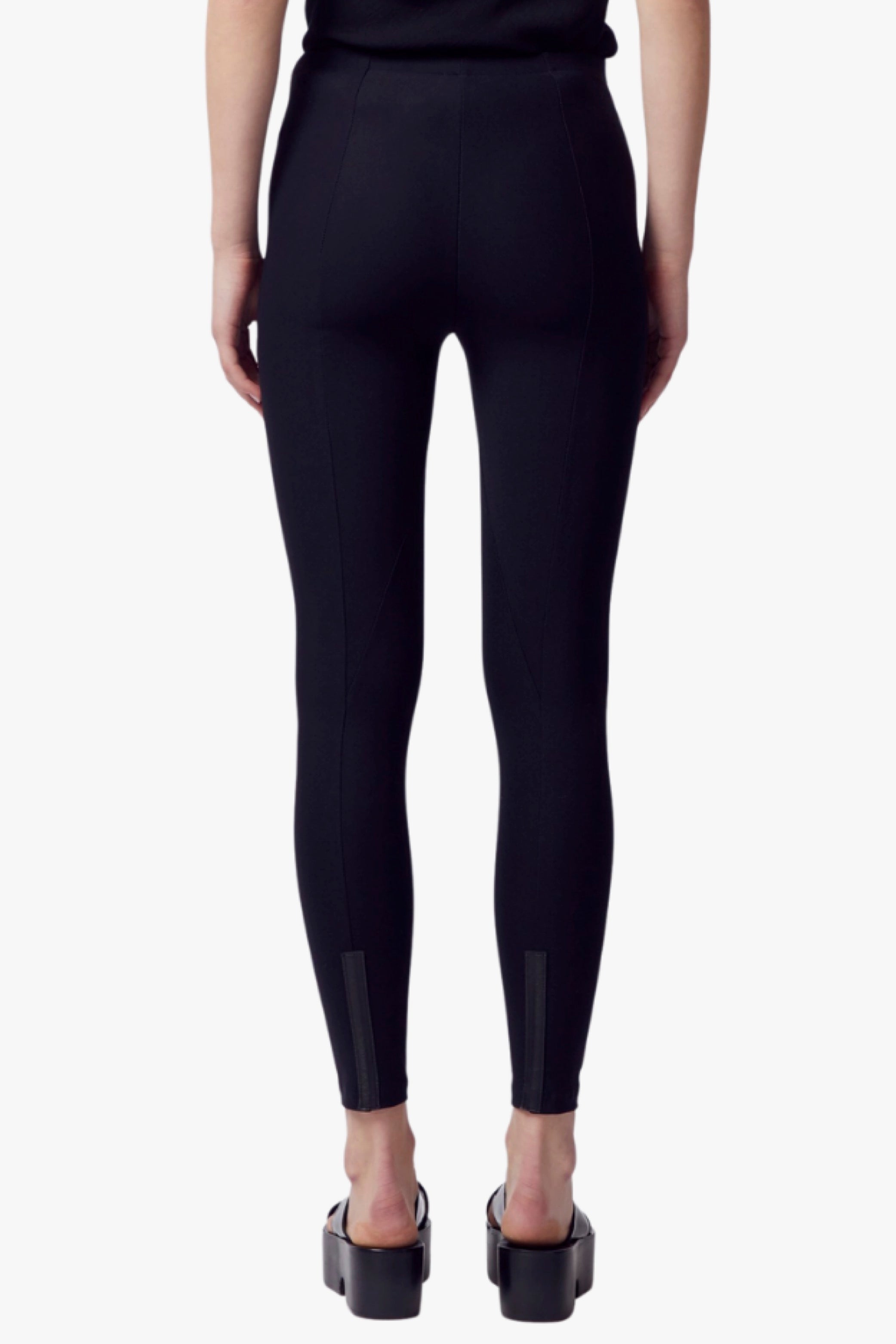 Black leggings worn by a person on a white background