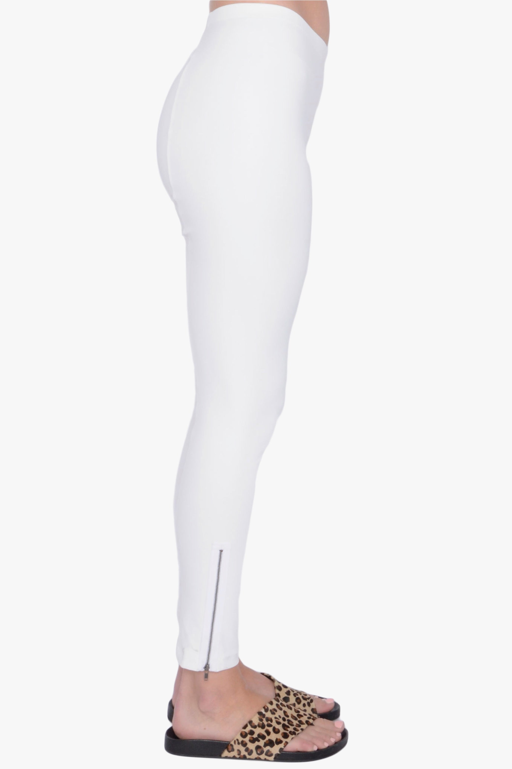 White leggings worn by a person on a white background