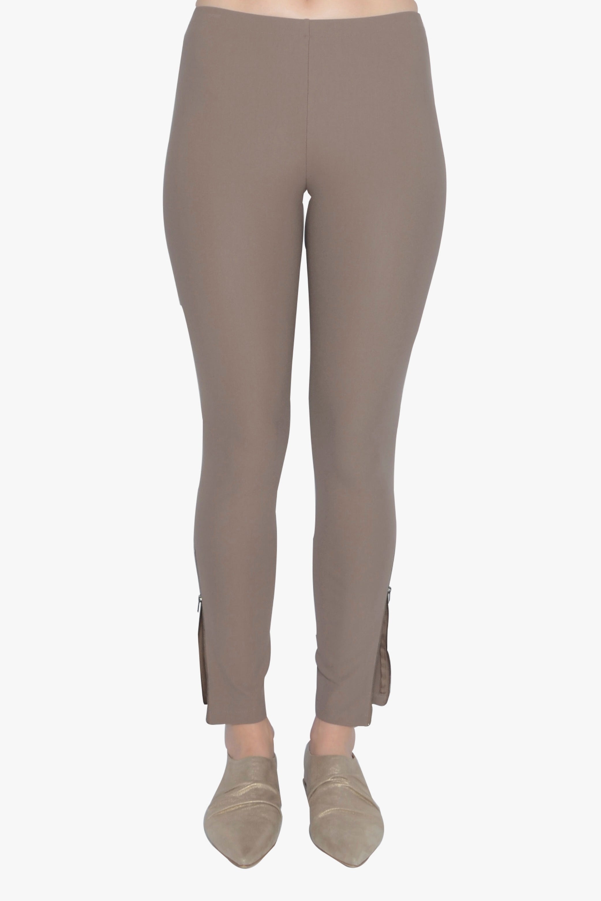 Beige leggings worn by a person on a white background