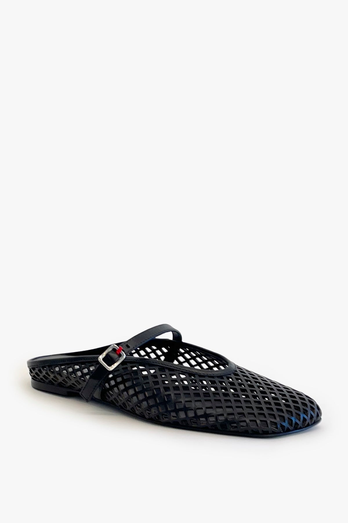 Black laser cut leather strap slip on flat shoe on a white background