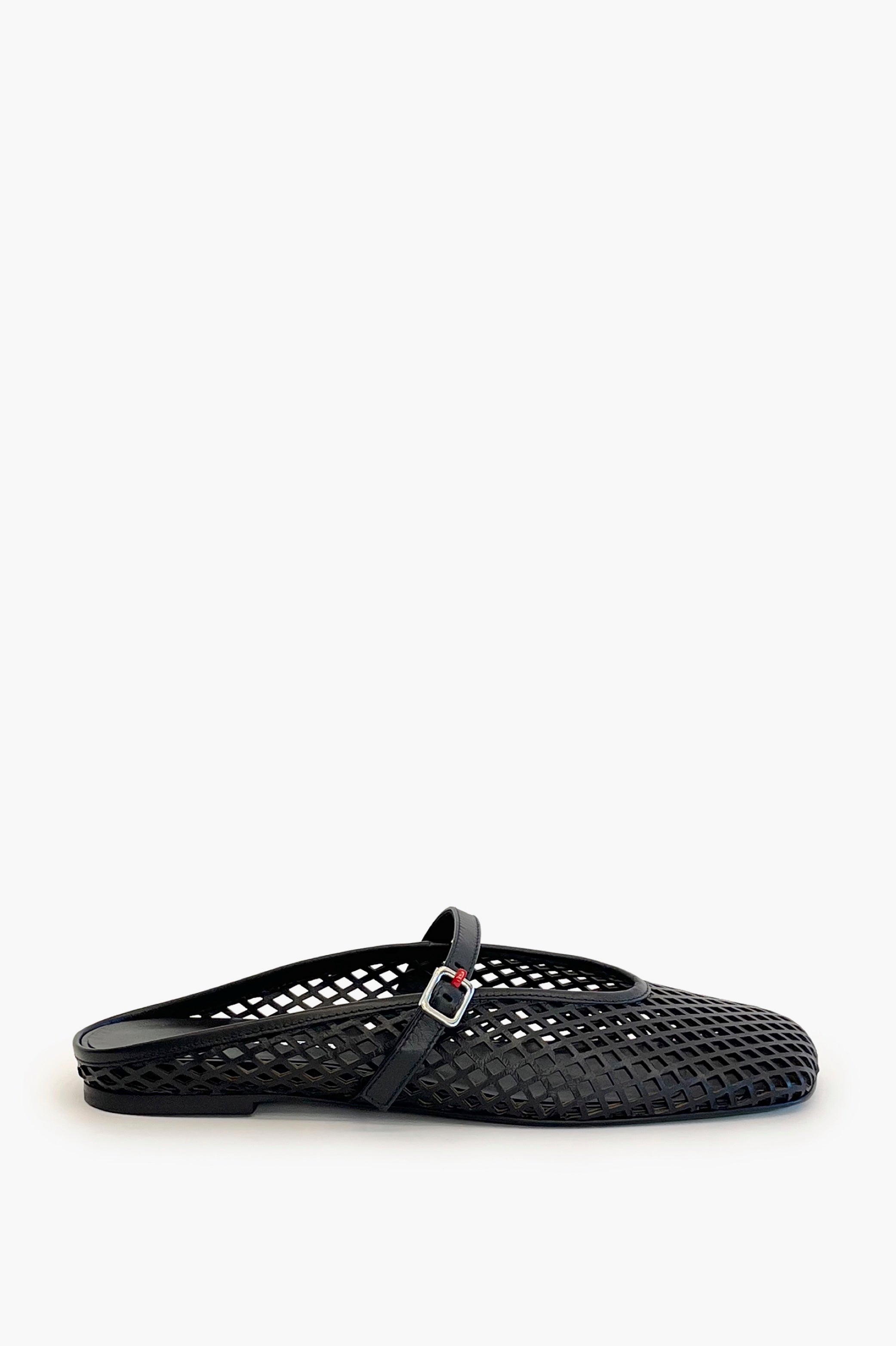Black laser cut leather strap slip on flat shoe on a white background