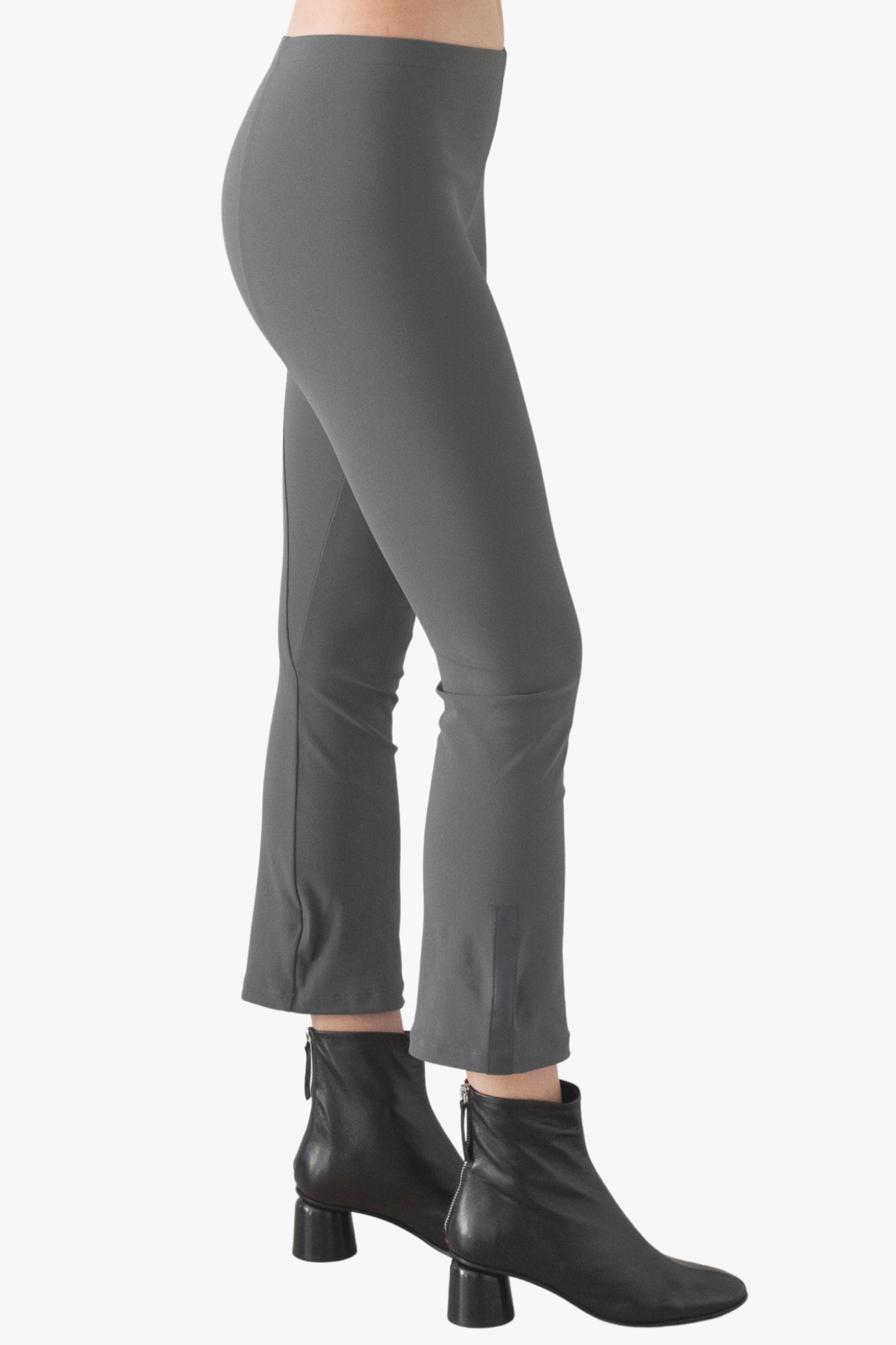 Gray pants worn by a person on a white background