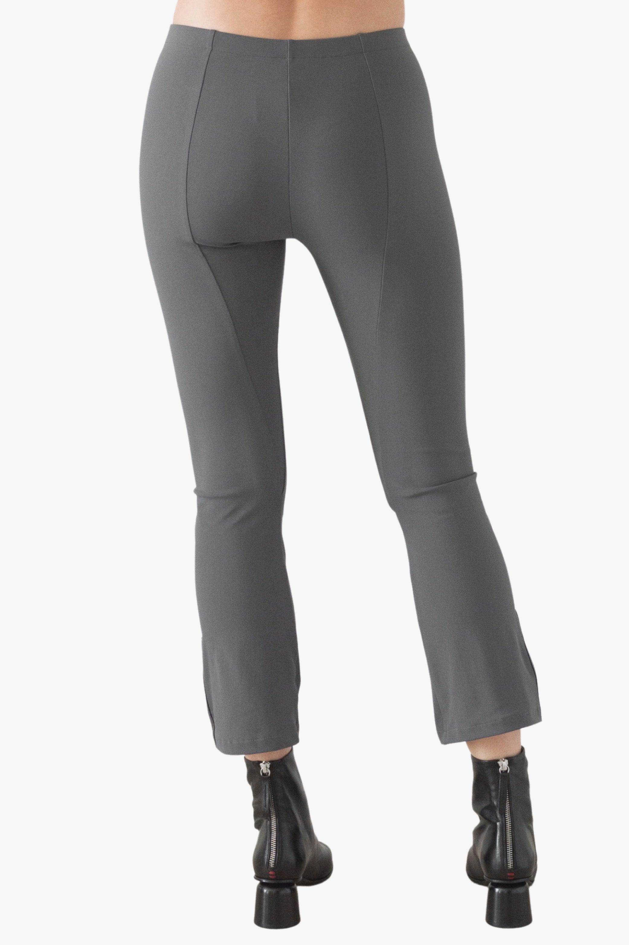 Gray pants worn by a person on a white background