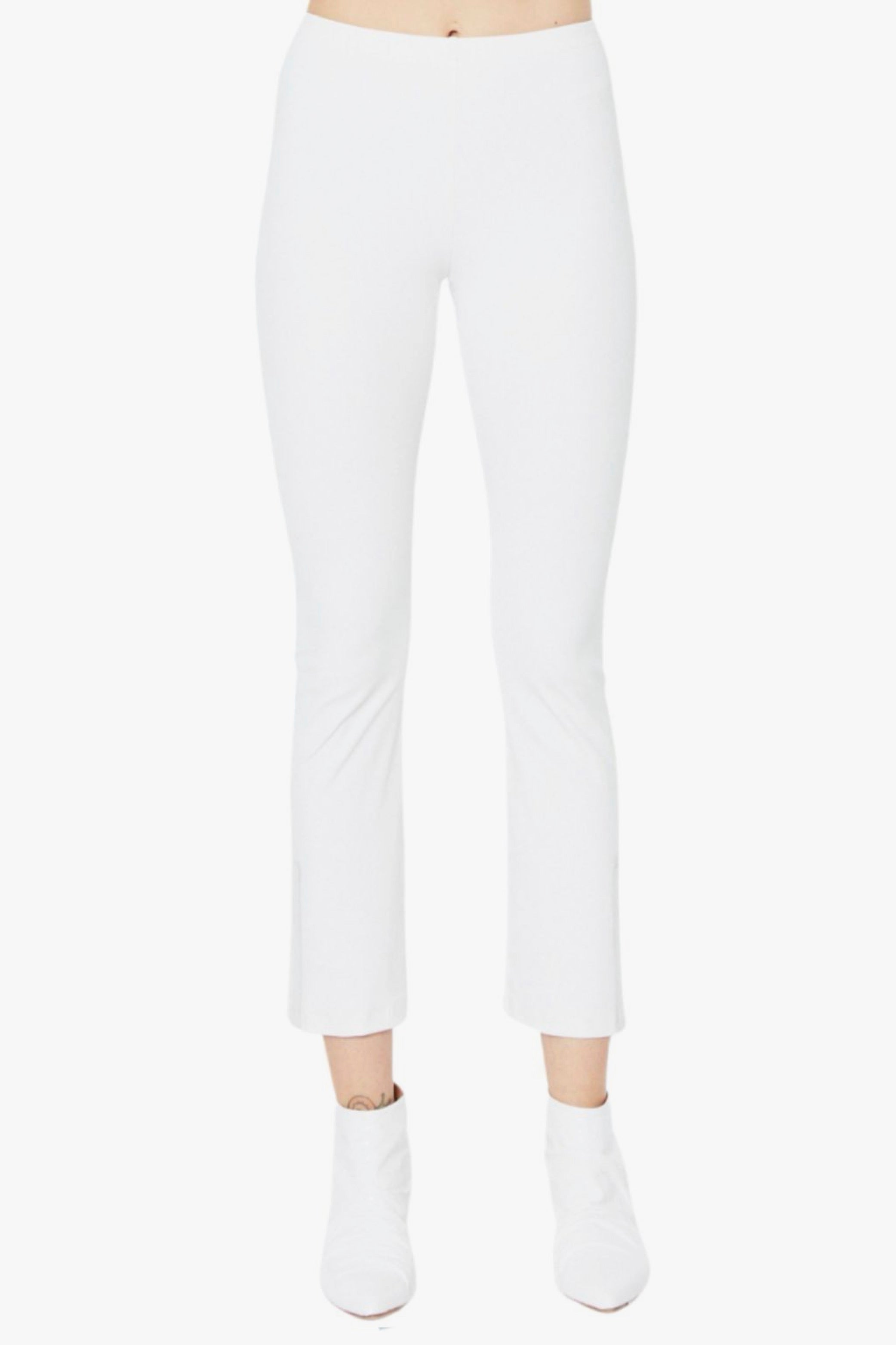 White pants worn by a person on a white background