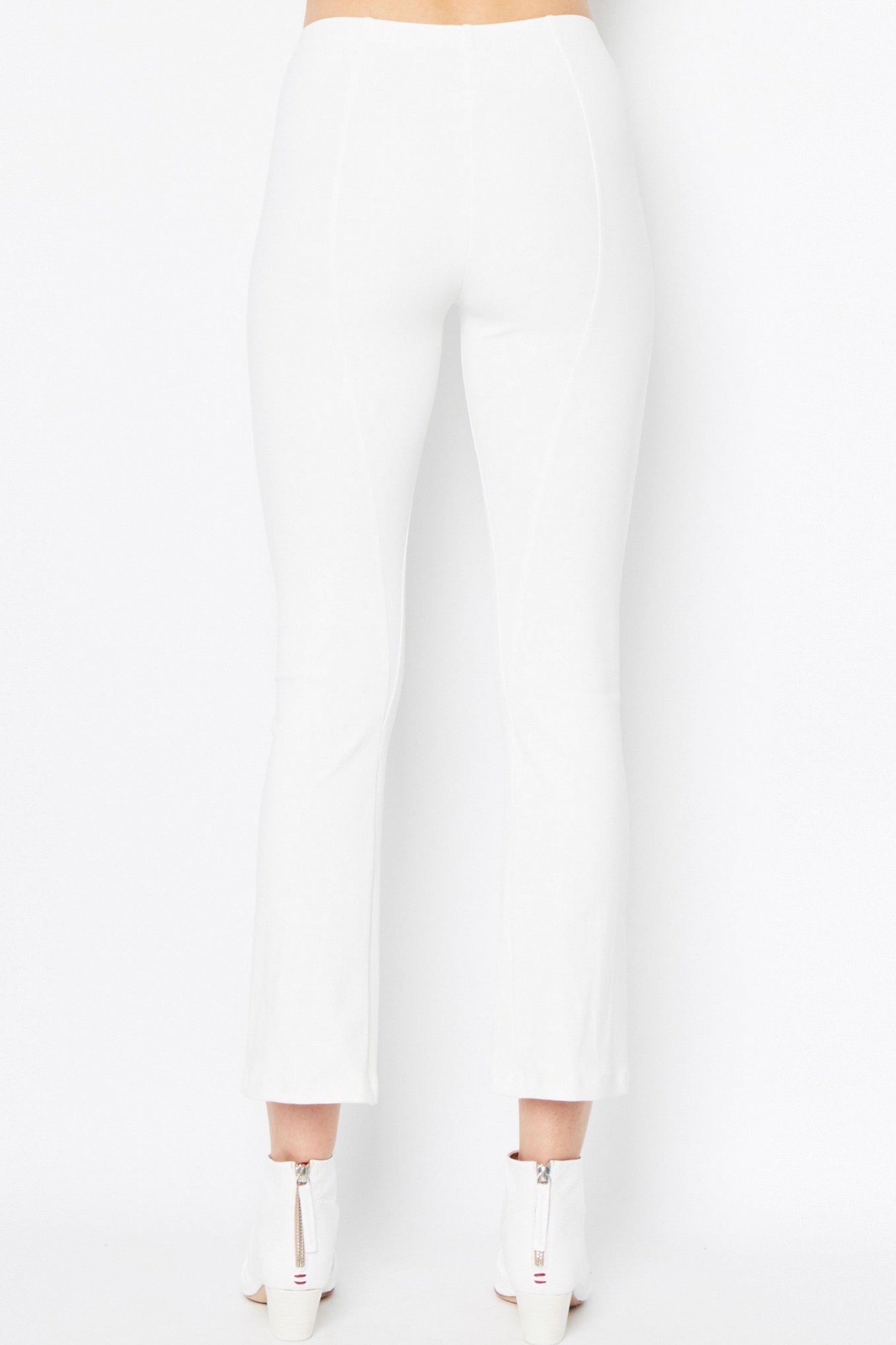 White pants worn by a person on a white background