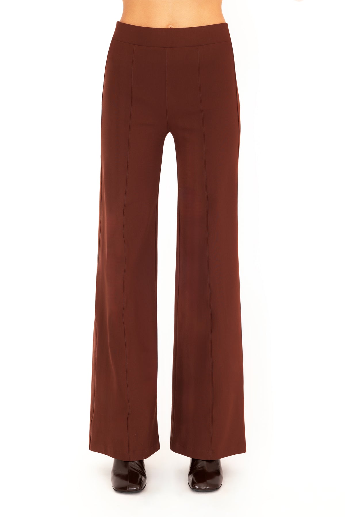 A model wearing high-waisted, wide-leg brown pants with dark brown boots, shown from the waist down against a plain white background.