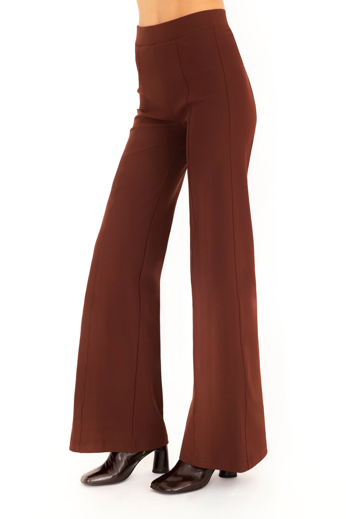 A model wearing high-waisted, wide-leg brown pants with dark brown boots, shown from the waist down against a plain white background.