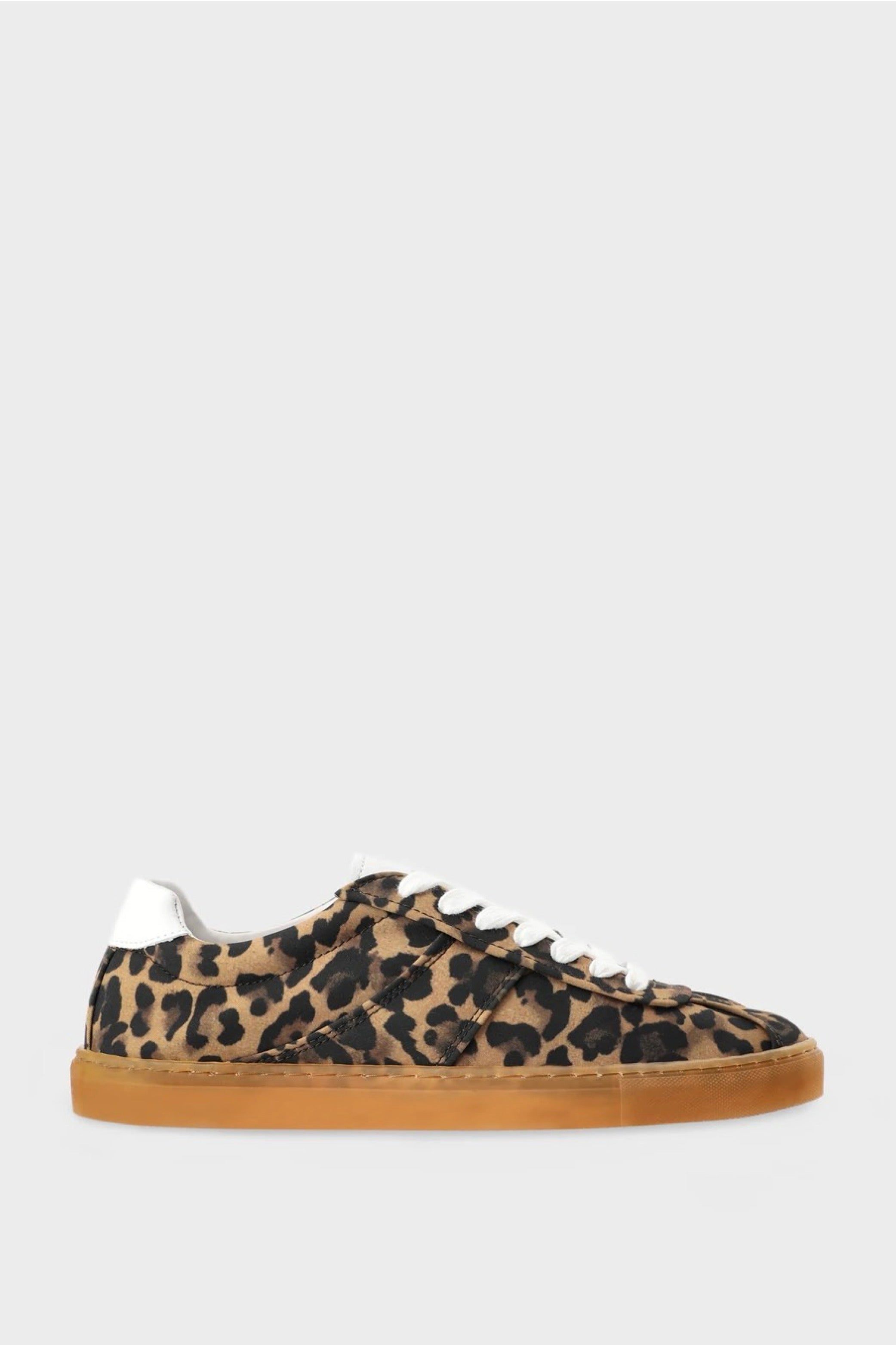 Leopard print sneaker with white laces on a light gray background