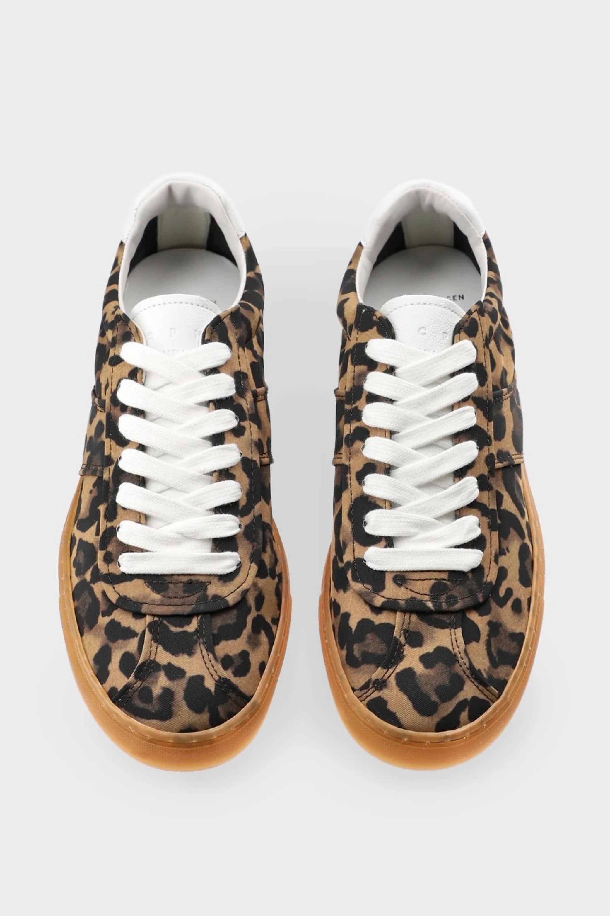 Leopard print sneaker with white laces on a light gray background