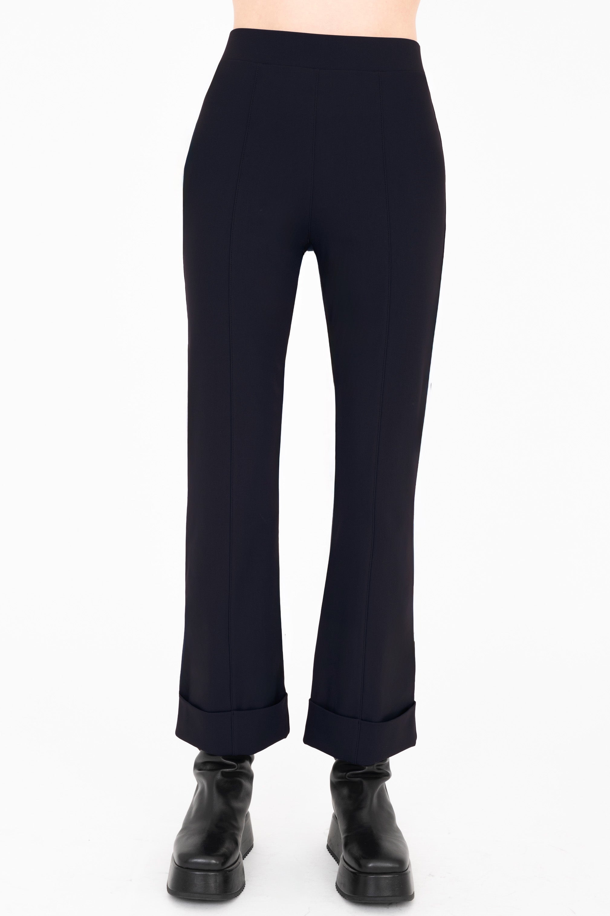 Dark blue pants worn by a person on a white background