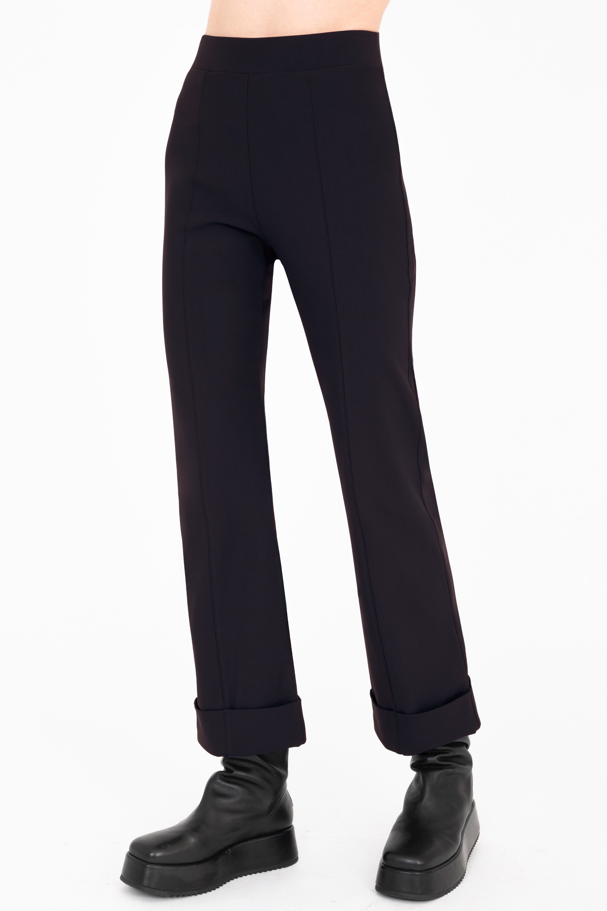 Dark blue pants worn by a person on a white background