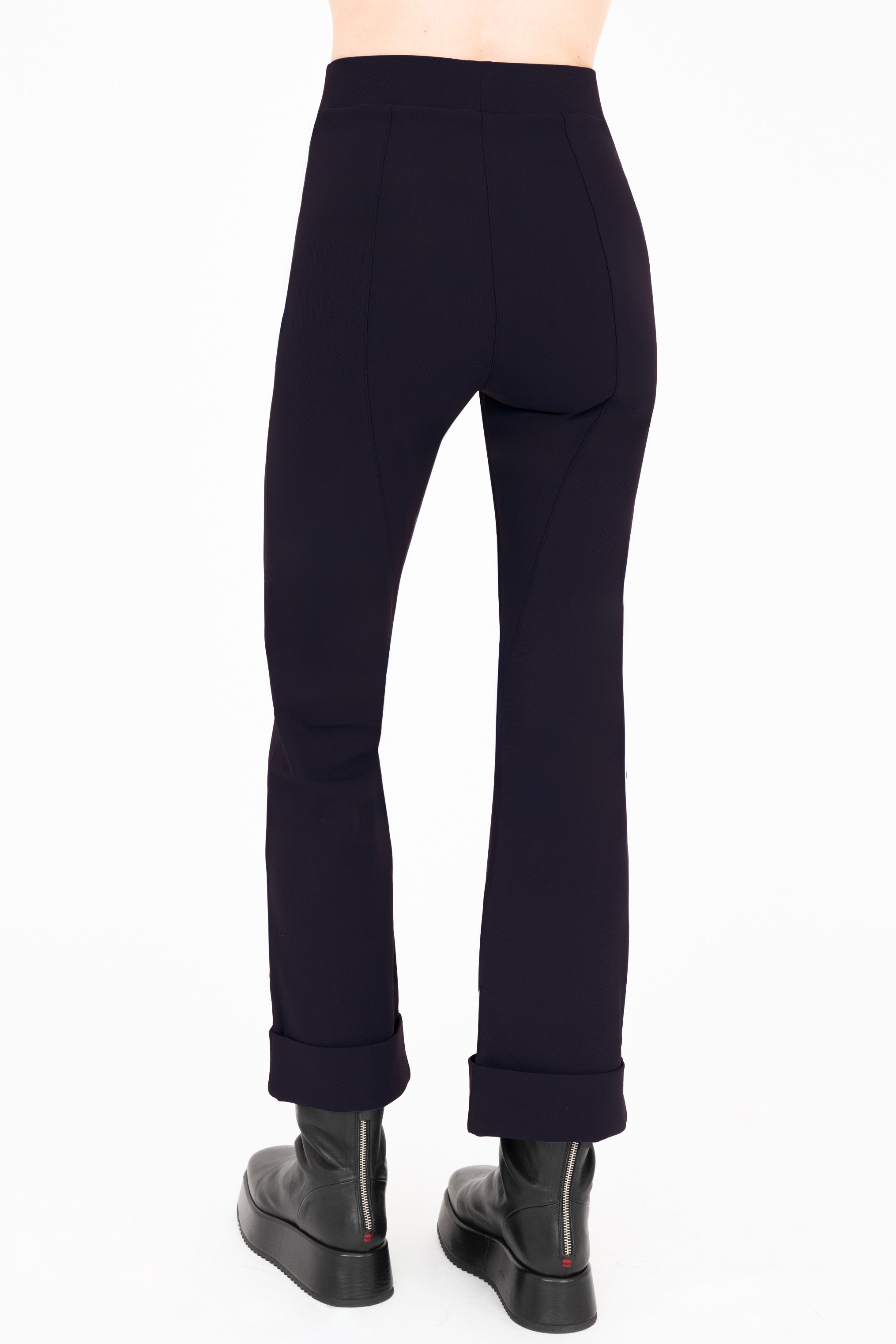 Dark blue pants worn by a person on a white background