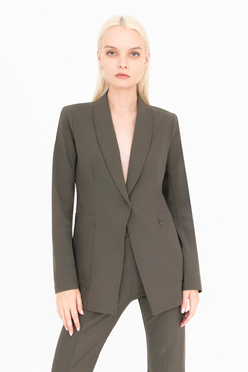 Woman wearing a olive suit on a white background