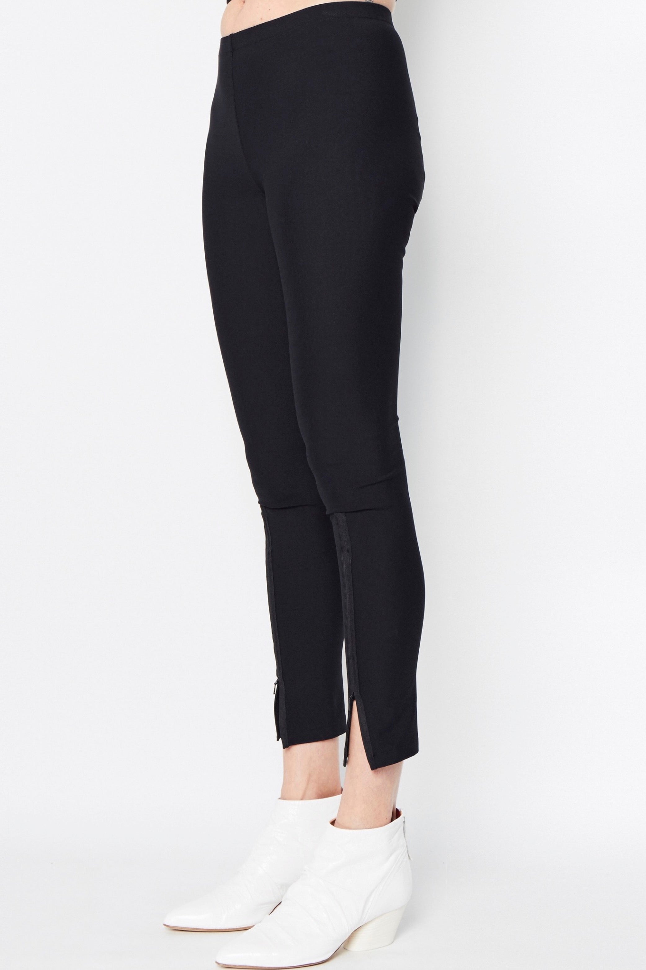 Black leggings with front slits on a white background