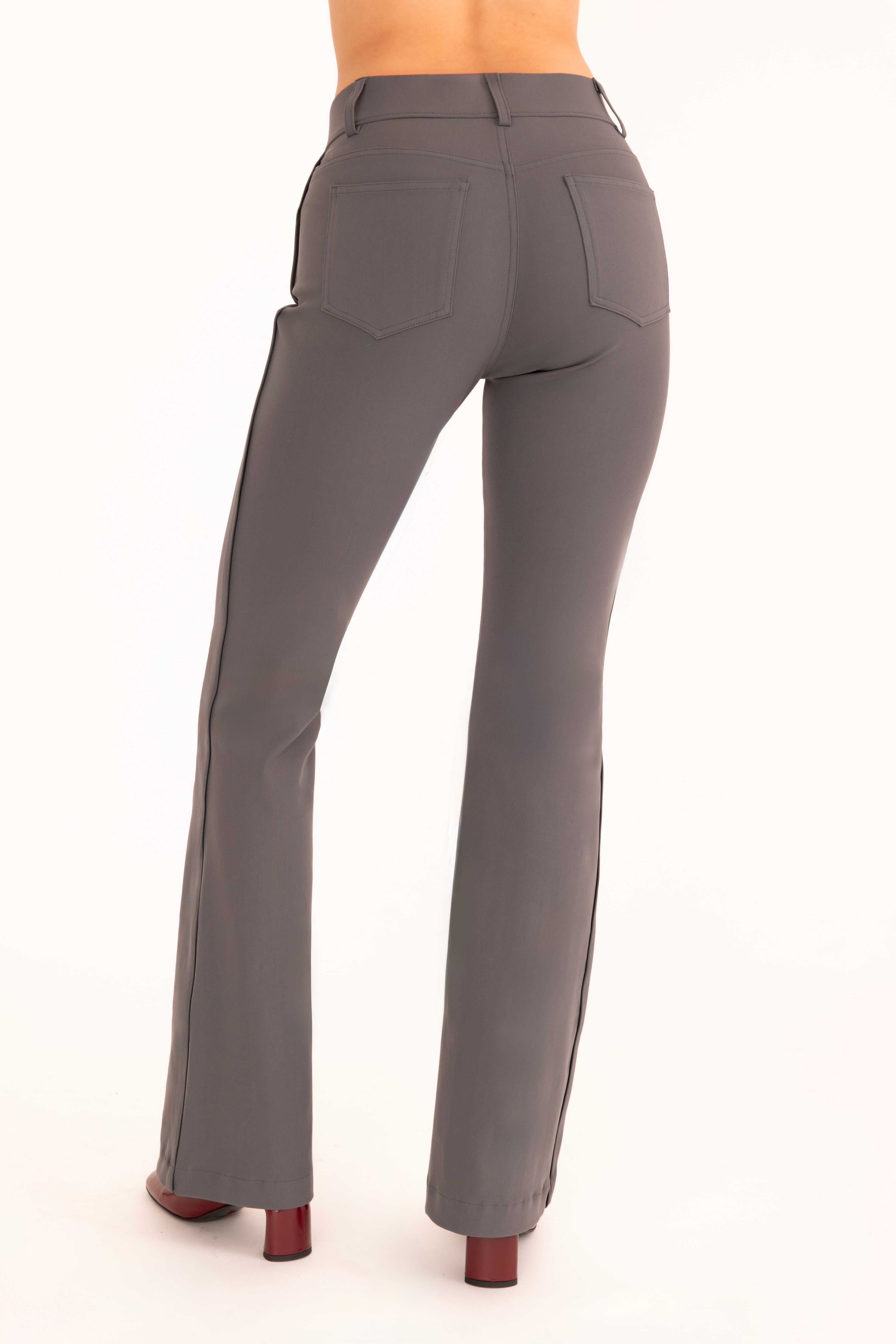 Back view of gray flare jean pants on a white background