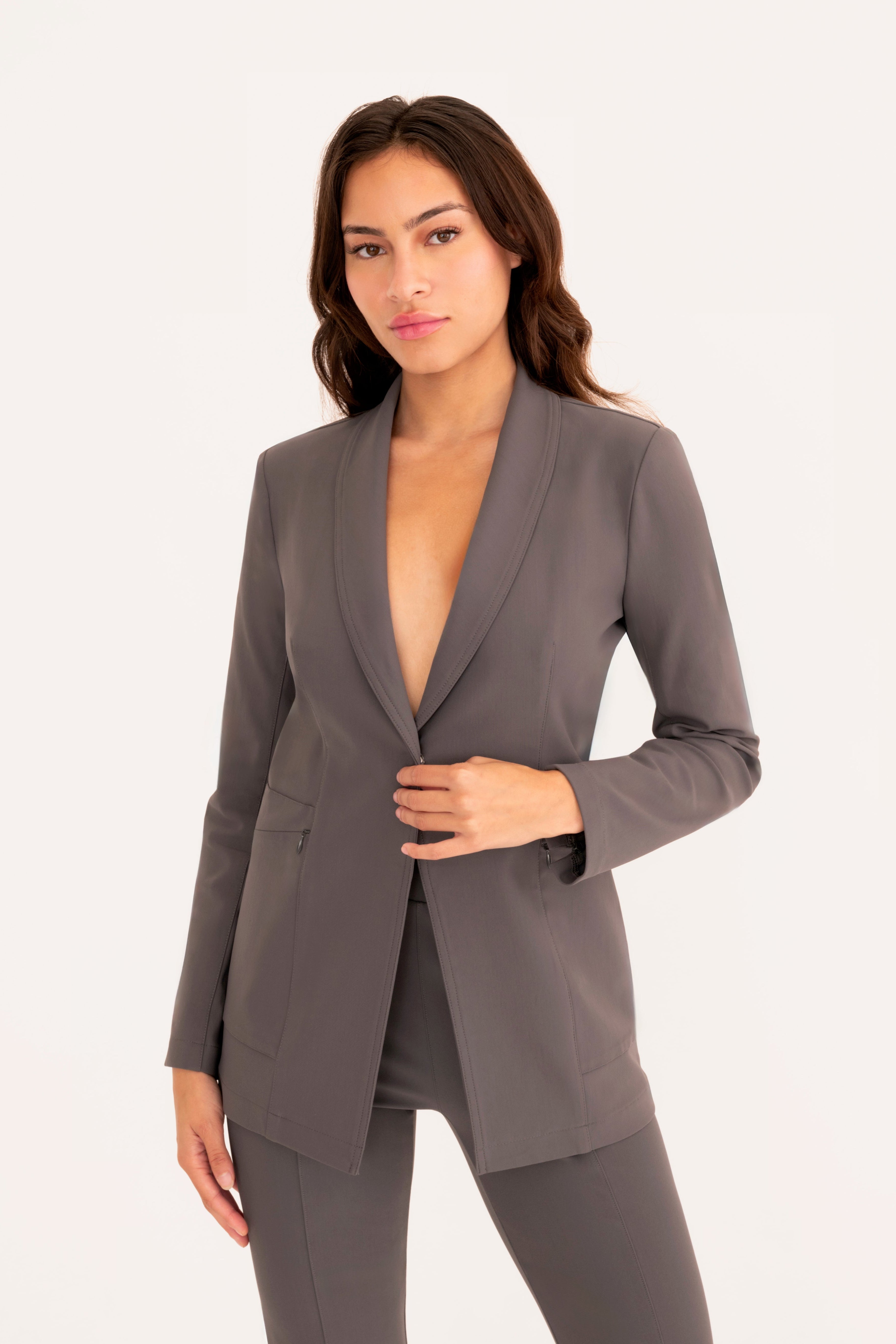 Woman wearing a gray suit on a white background