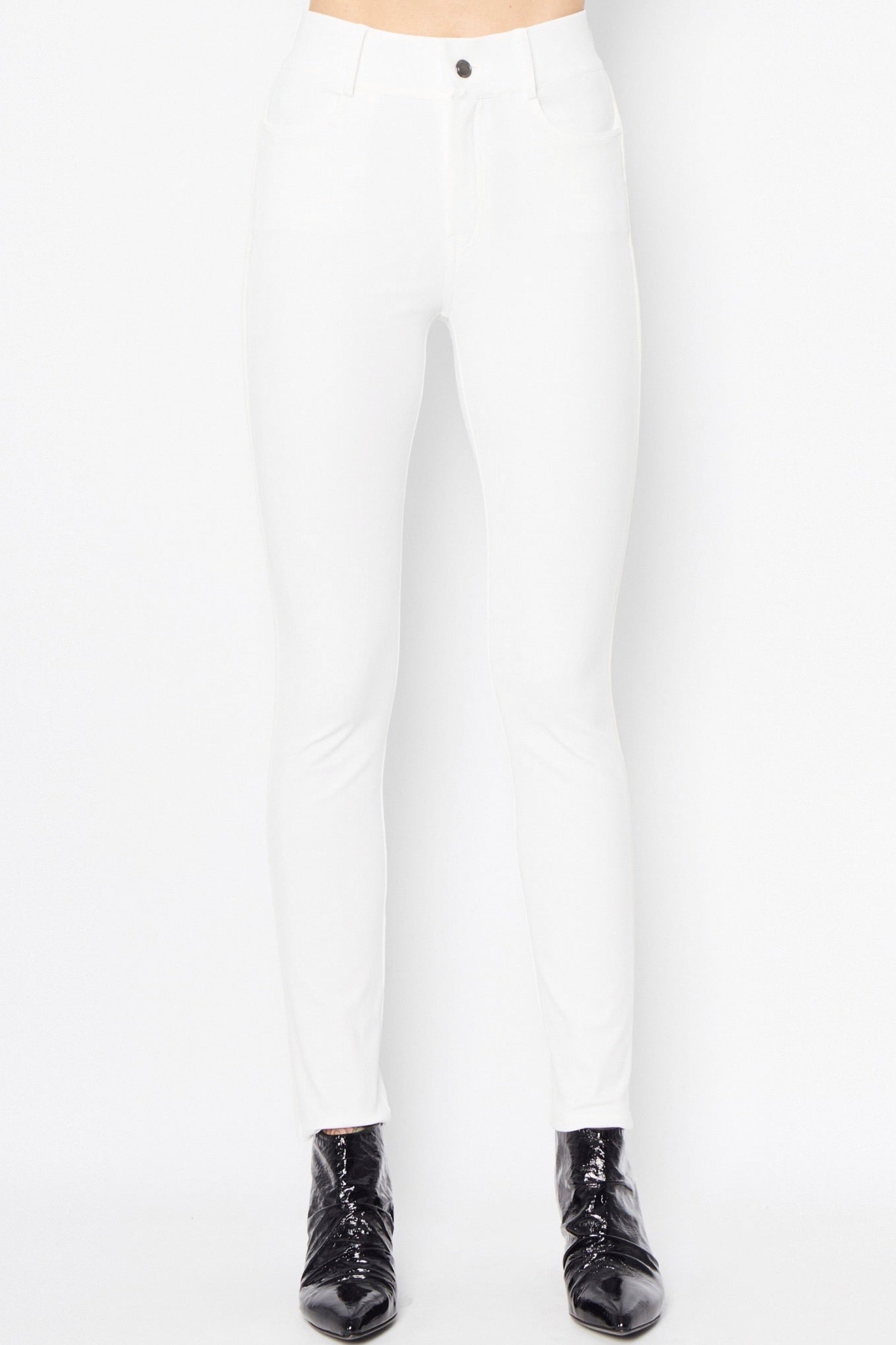 White pants worn by a person on a white background