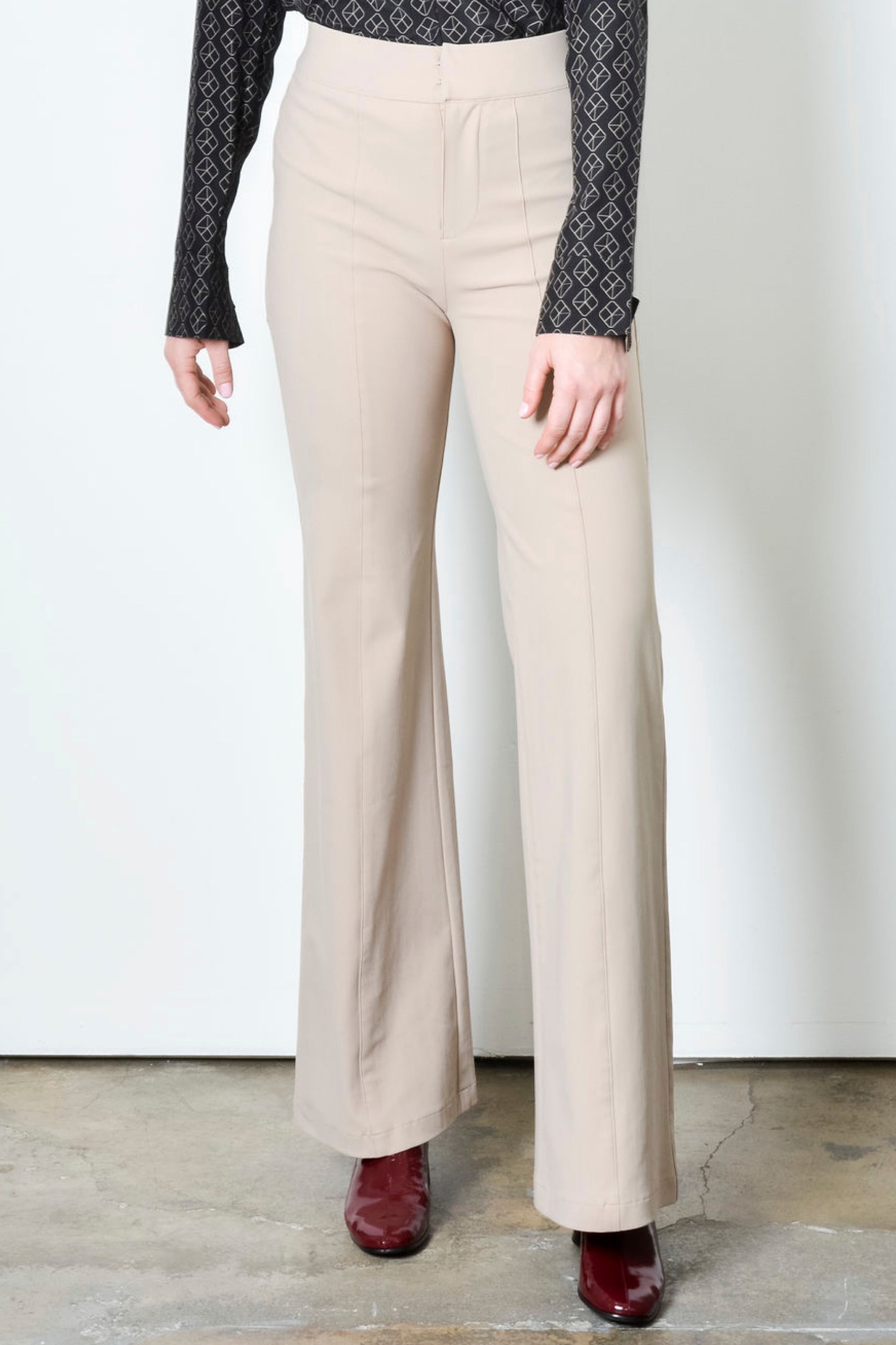 Beige wide leg pants on a plain background