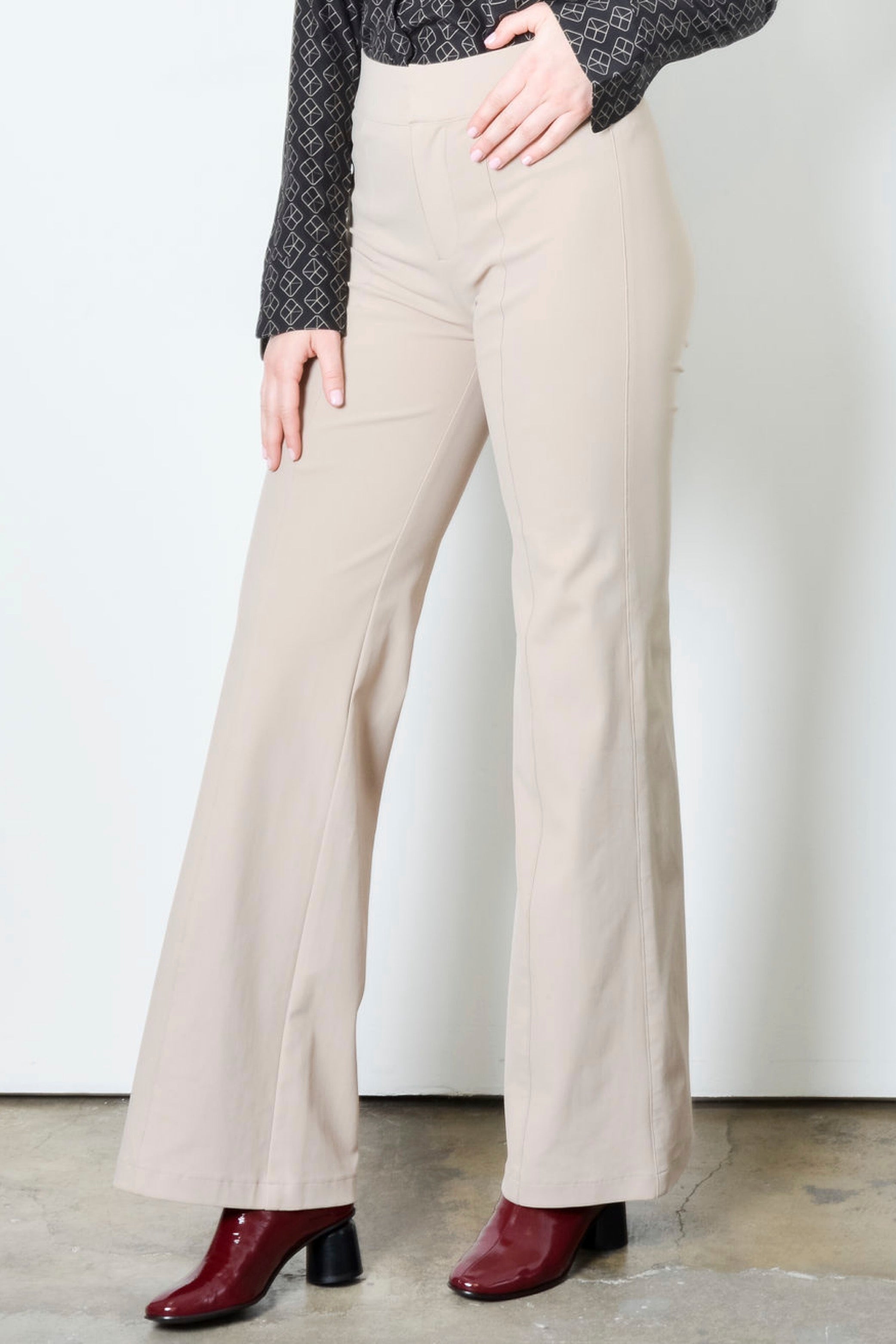 Beige wide leg pants on a plain background