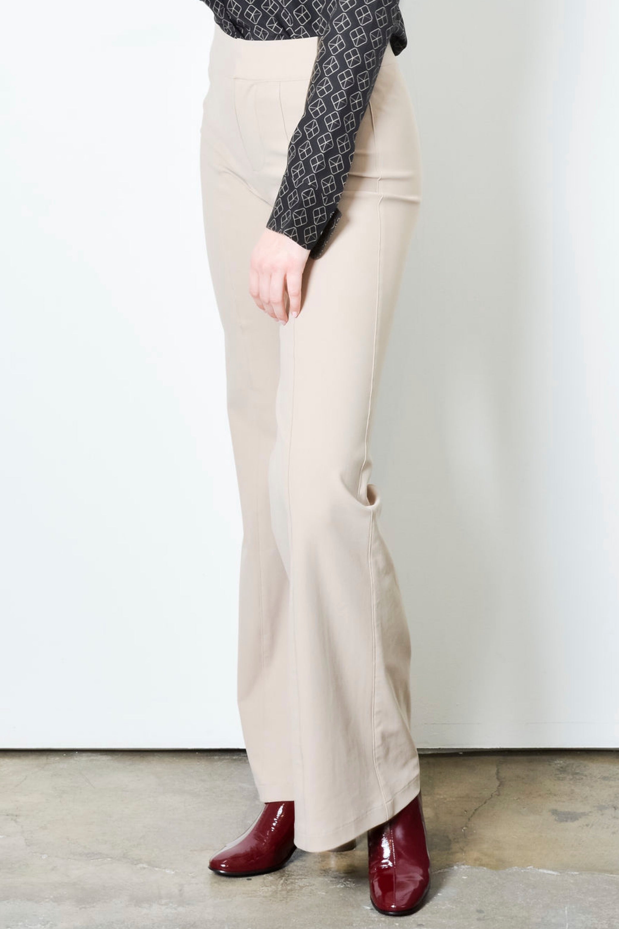 Beige wide leg pants on a plain background