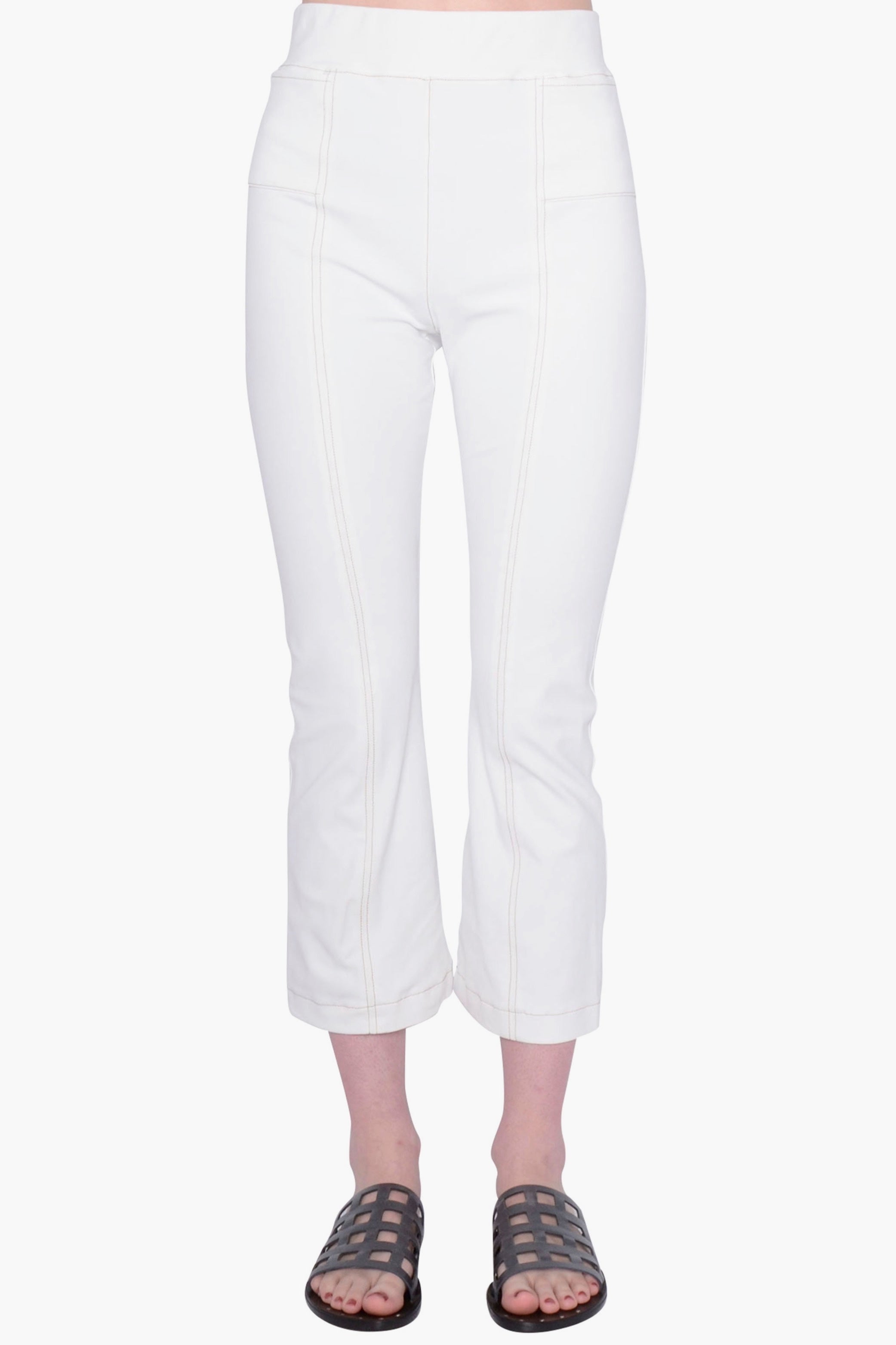 White pants worn by a person on a white background