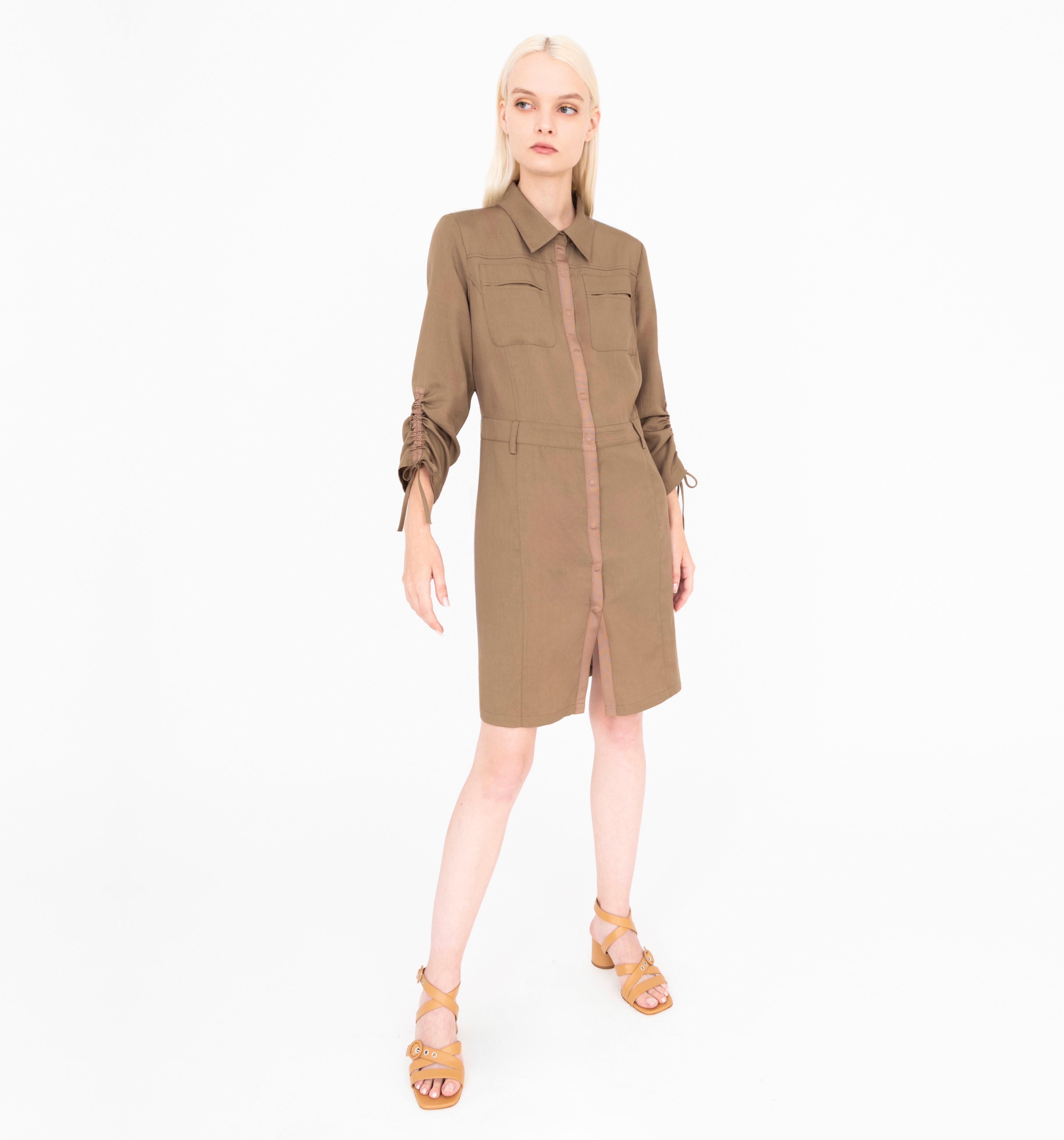 Woman wearing a brown dress with a white background