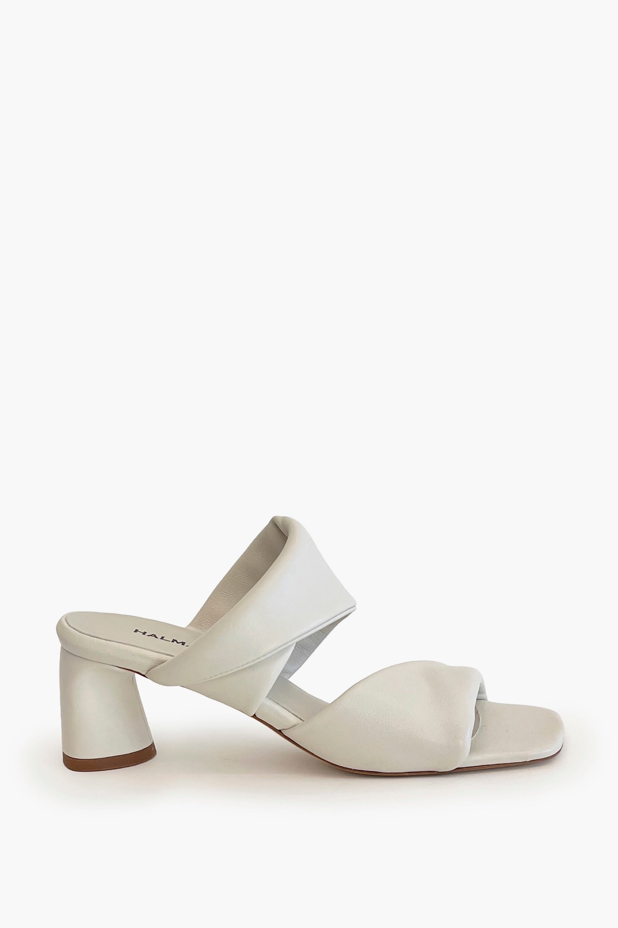 Ivory sculptured chunky heel sandal on a white background