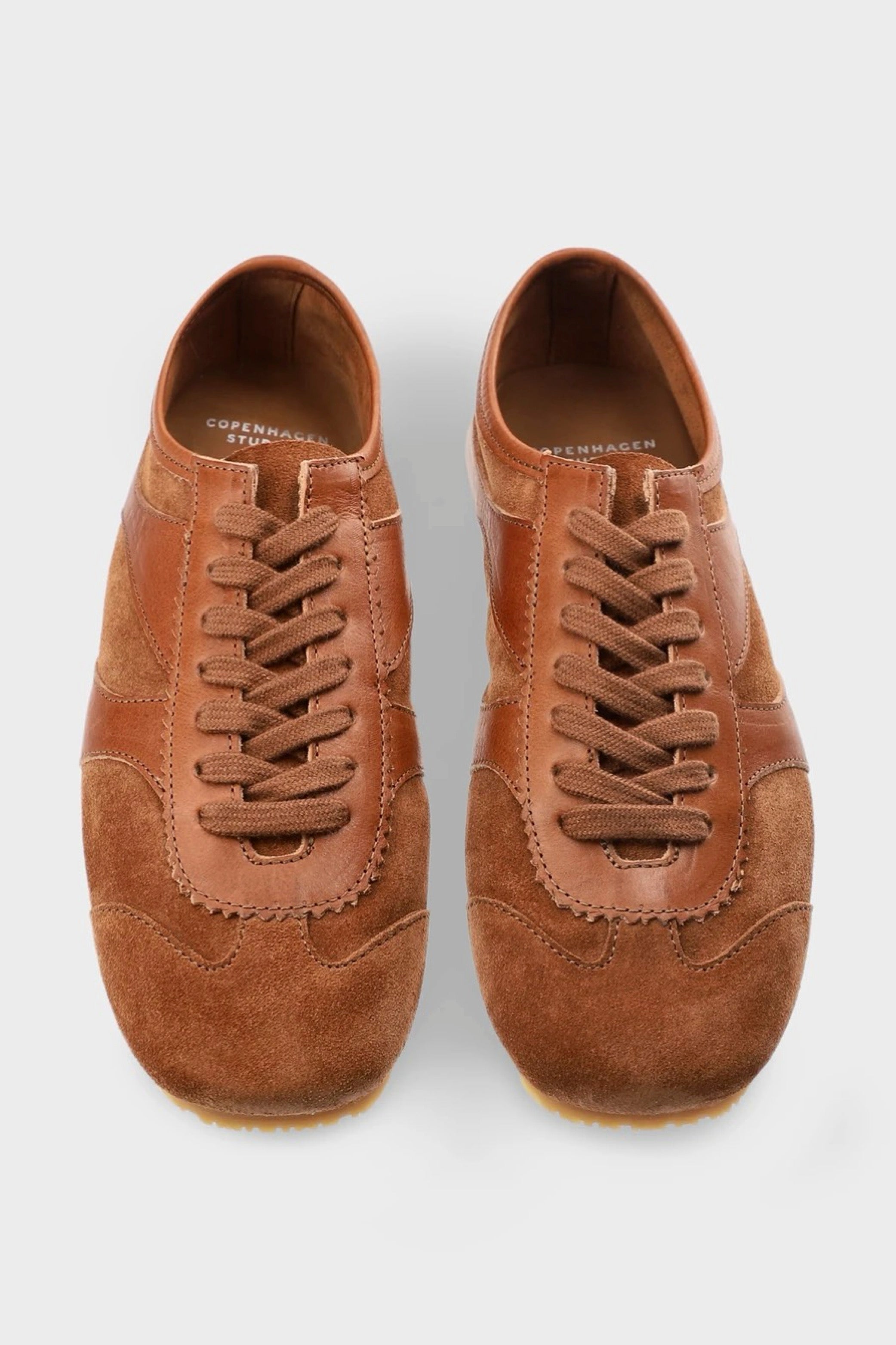 Pair of brown suede shoes on a white background