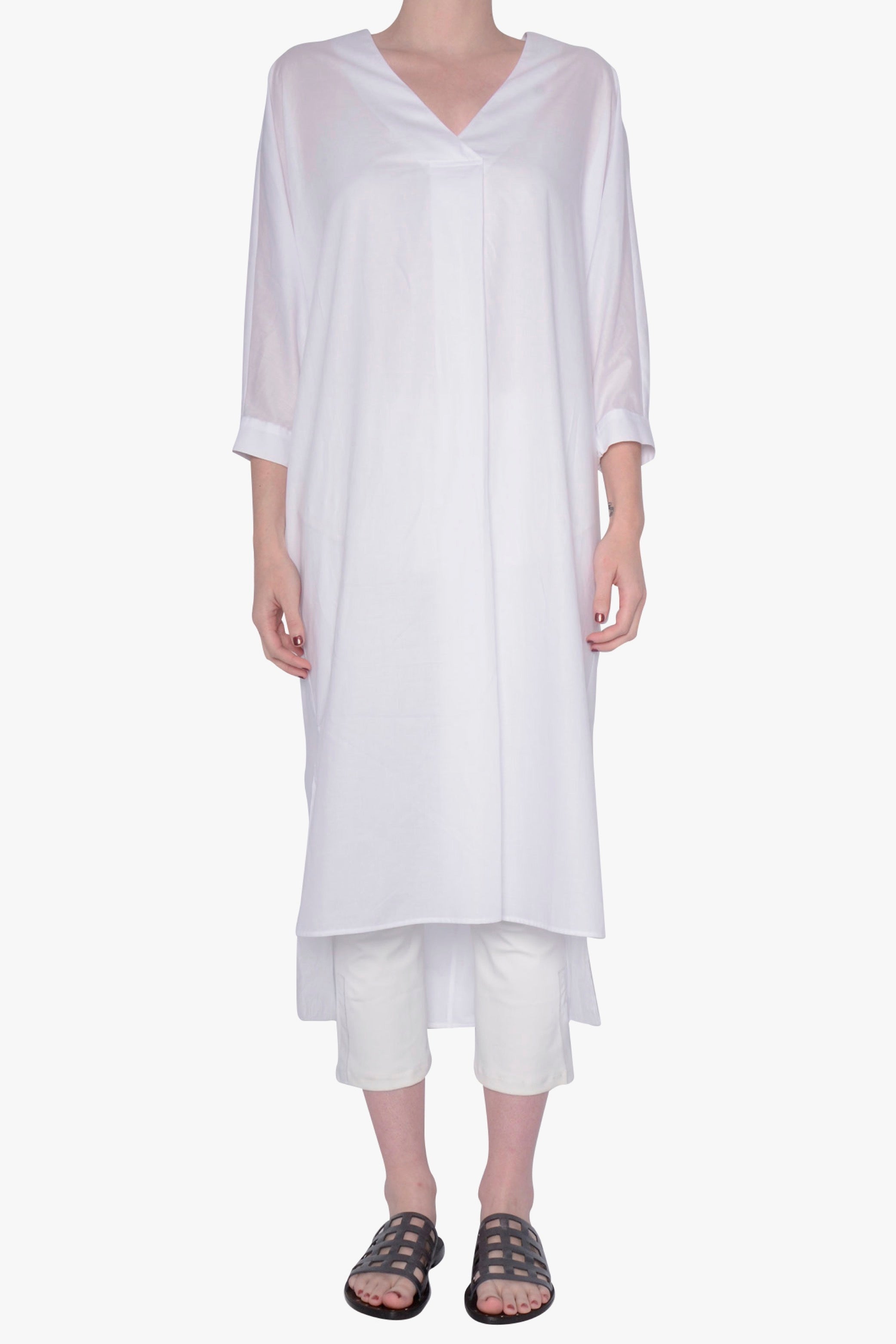 White long-sleeve dress against a white background