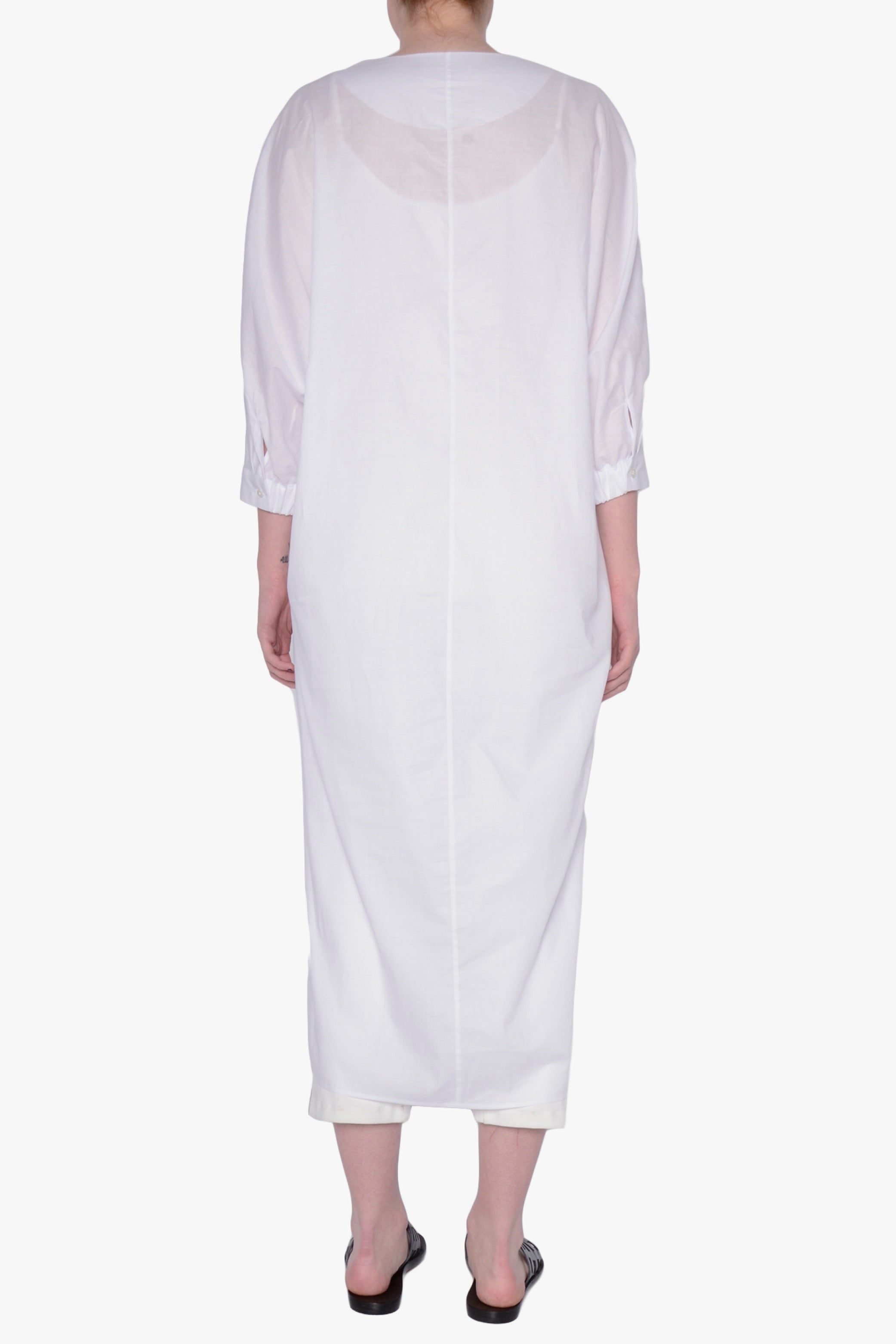 White long-sleeve dress against a white background