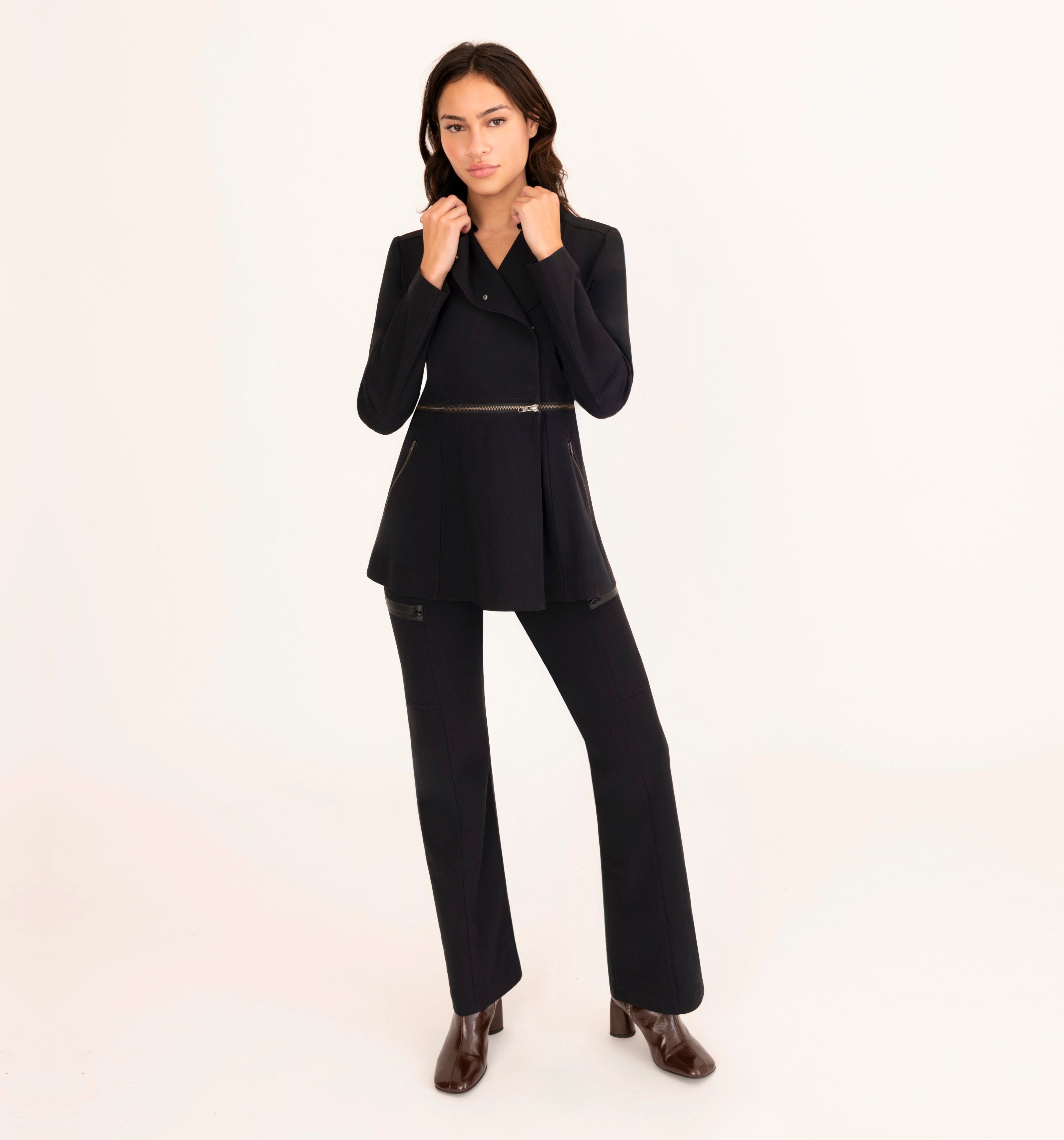 Woman wearing a black suit on a white background