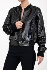 Black sequin bomber jacket worn by a model on a white background