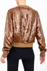 Bronze sequin bomber jacket worn by a model on a white background