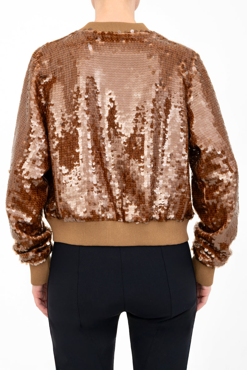 Bronze sequin bomber jacket worn by a model on a white background