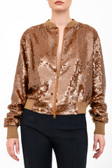 Bronze sequin bomber jacket worn by a model on a white background