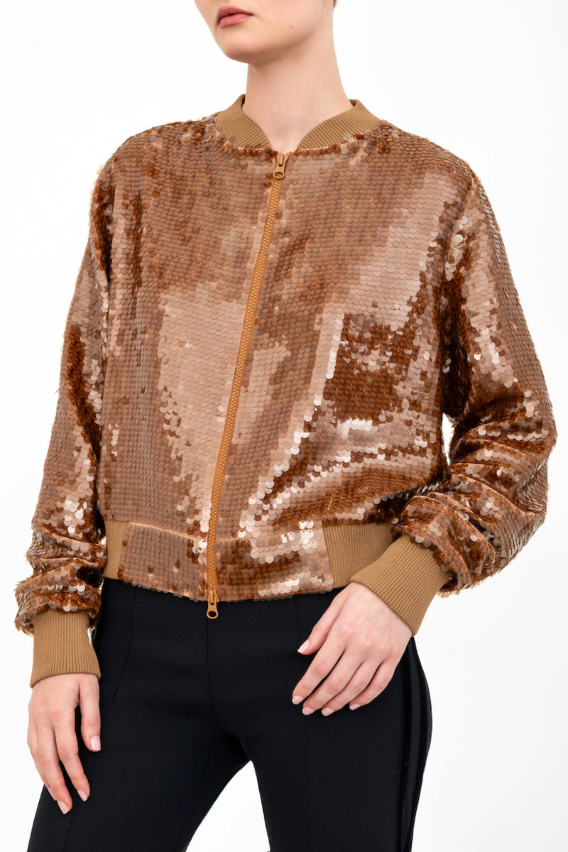 Bronze sequin bomber jacket worn by a model on a white background