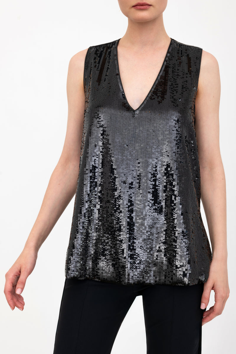 Black sequin sleeveless top worn by a model on a white background