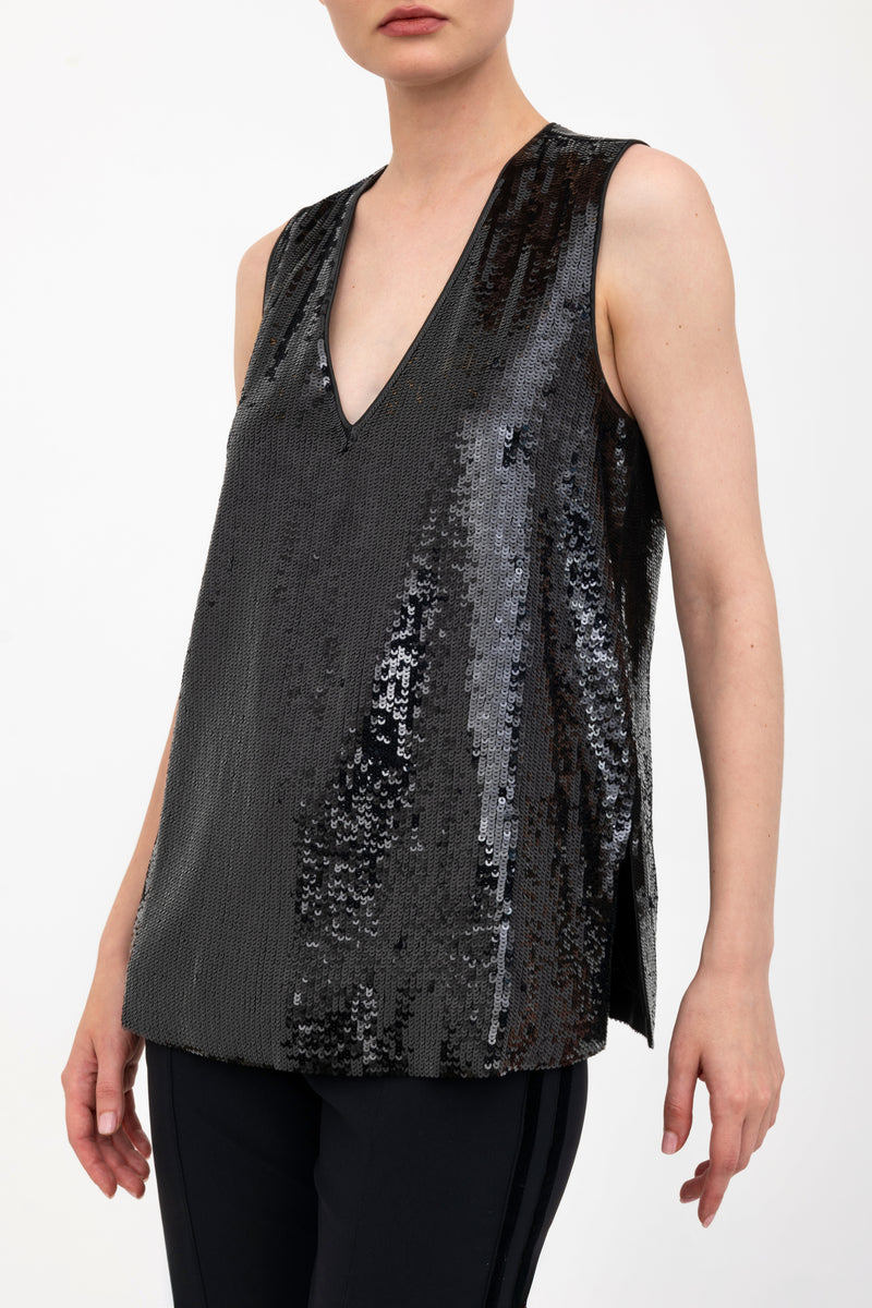 Black sequin sleeveless top worn by a model on a white background