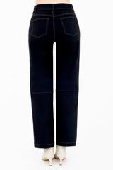 Black jeans worn by a person on a white background