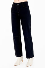 Black jeans worn by a person on a white background