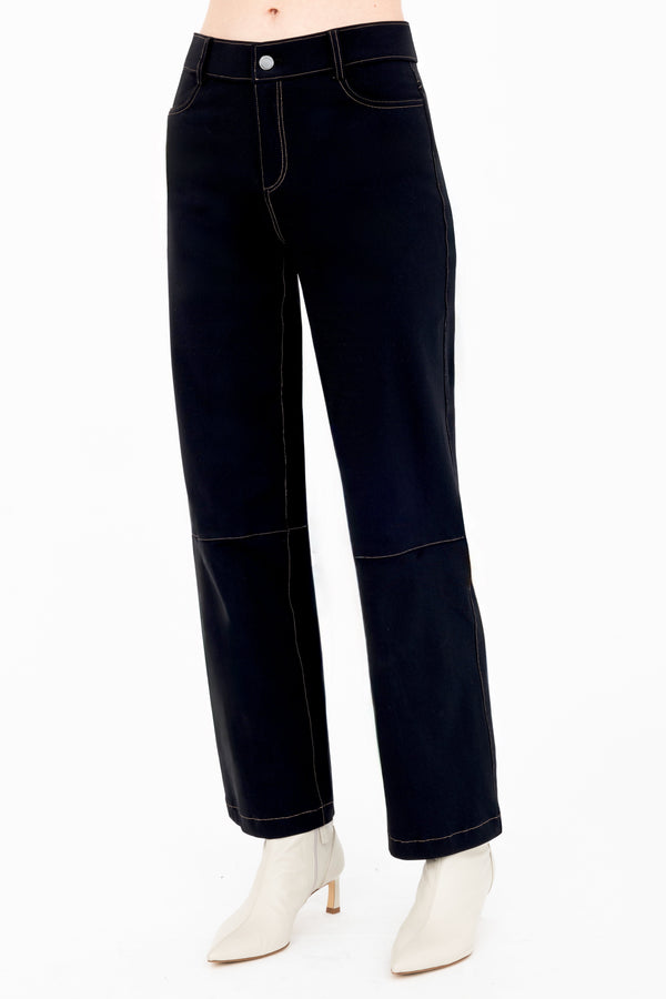 Black jeans worn by a person on a white background